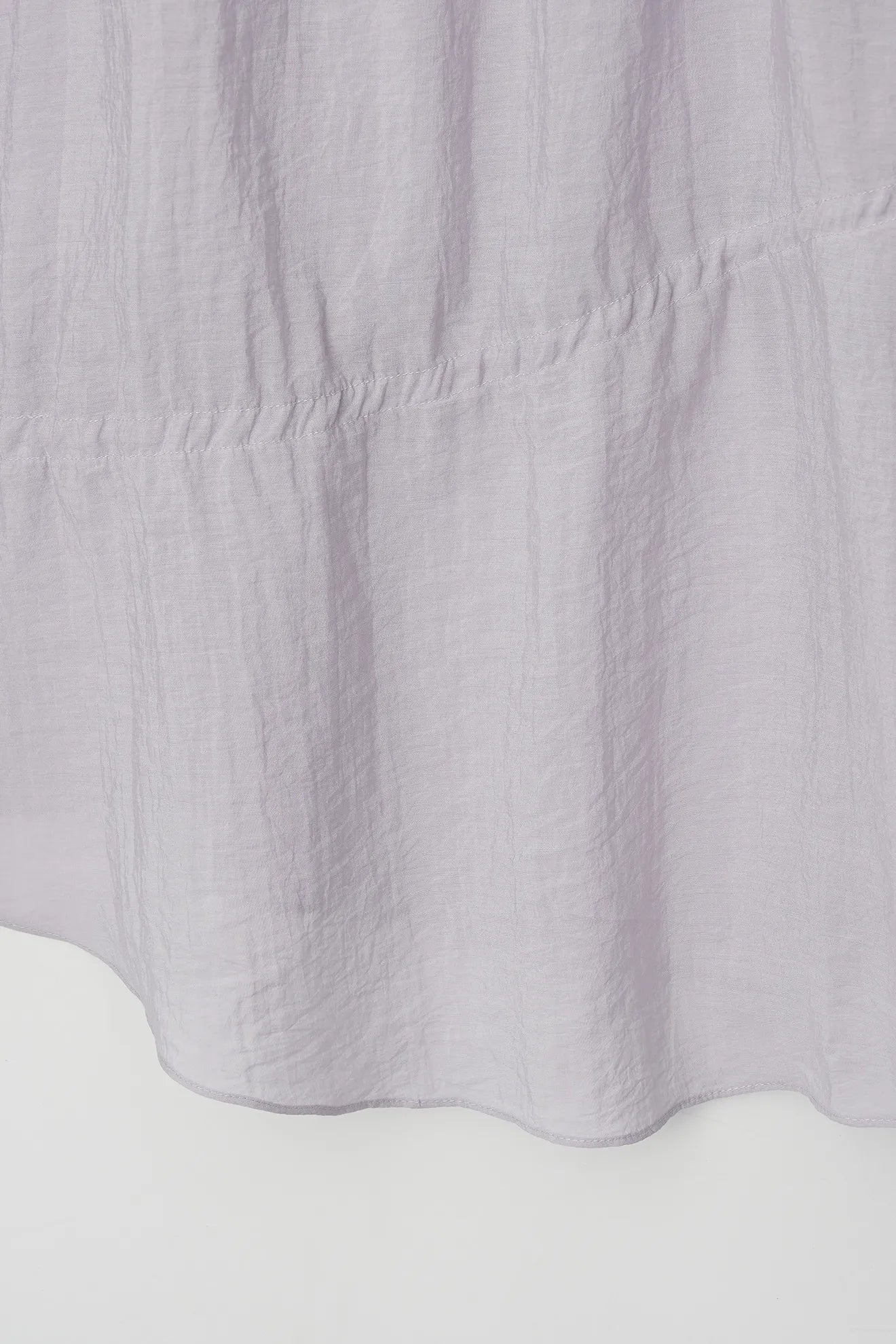 Asymmetrical hem detail of Asymmetrical Waist-Tie Dress in Purple