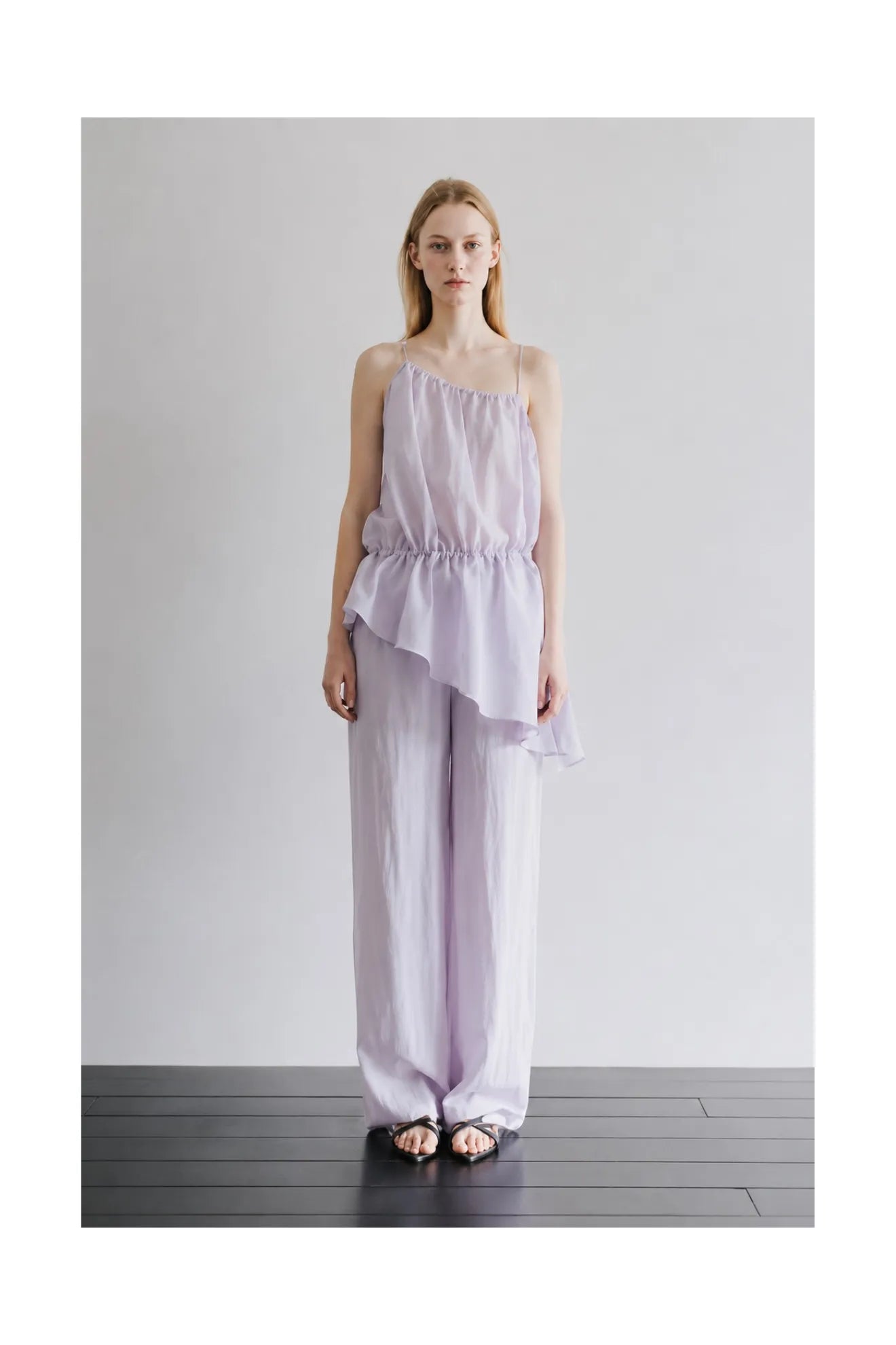Model wearing Atelier Edition Asymmetrical Waist-Tie Dress in Purple