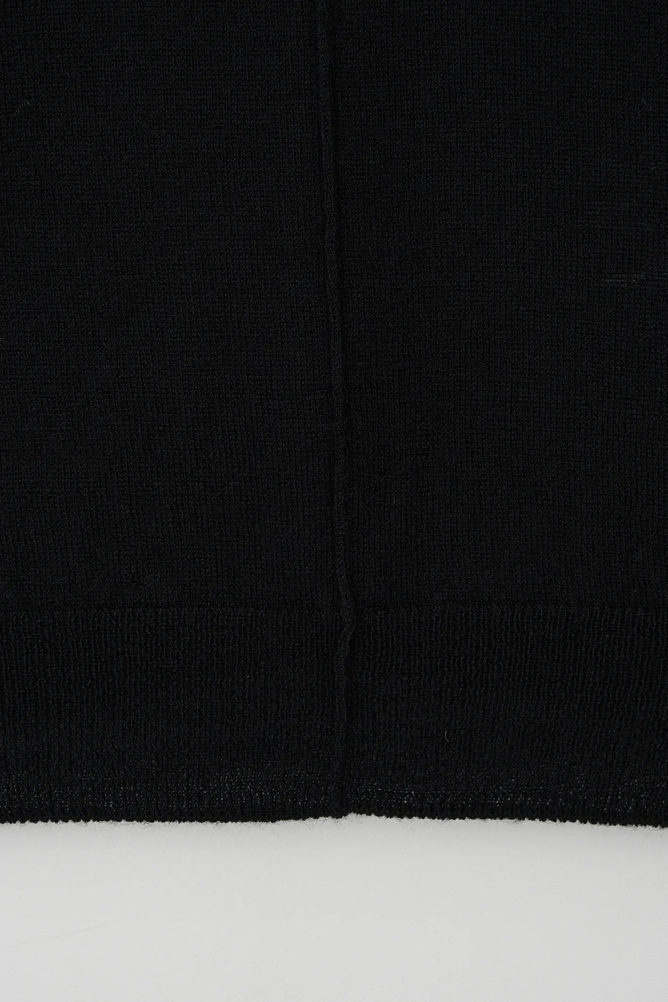 Atelier Edition Cut-Out Detail Wool Knit Top in Black hem detail