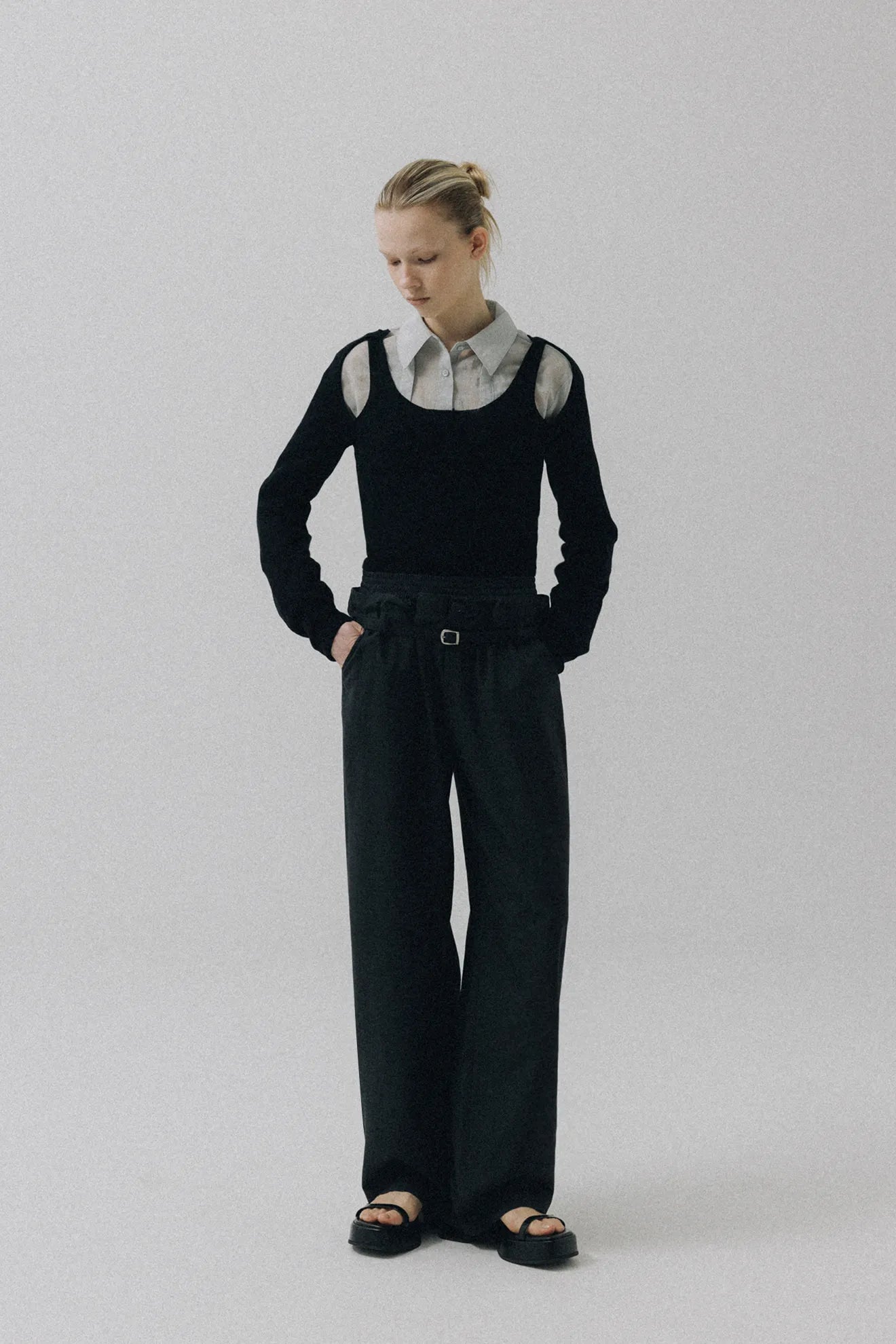 Model wearing Atelier Edition Cut-Out Detail Wool Knit Top in Black