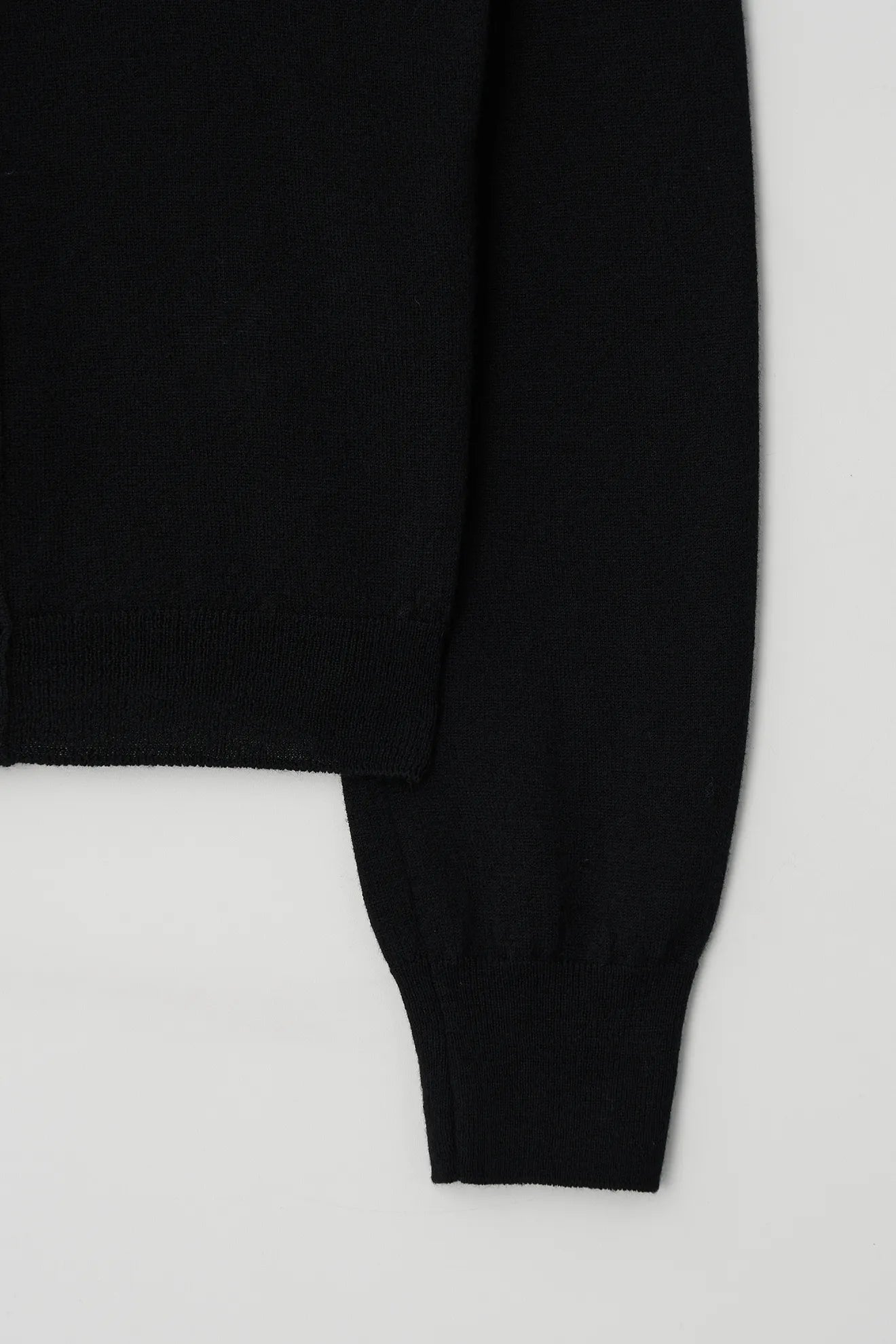 Atelier Edition Cut-Out Detail Wool Knit Top in Black sleeve cuff detail