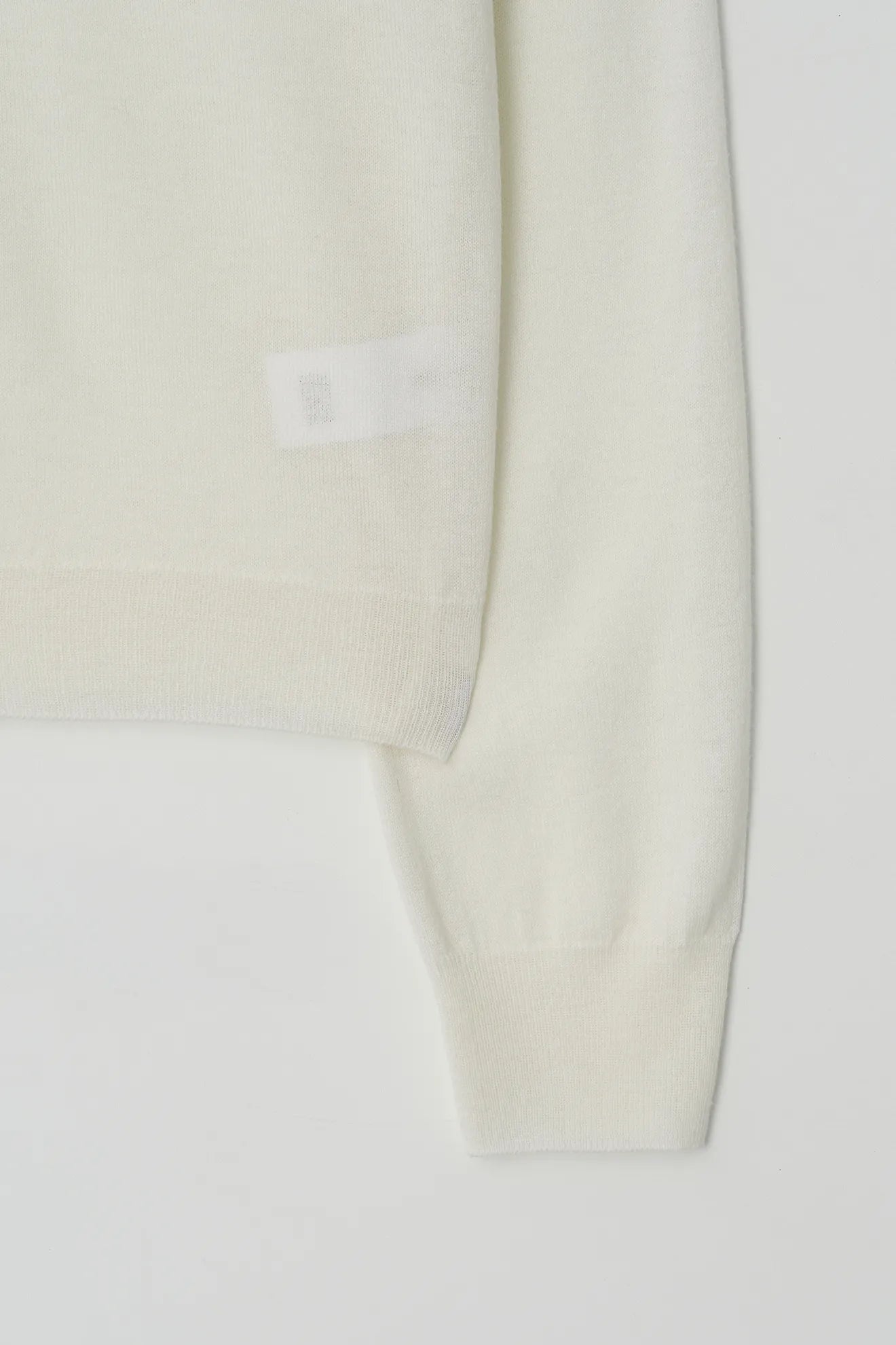 Atelier Edition Cut-Out Detail Wool Knit Top in Cream sleeve cuff detail