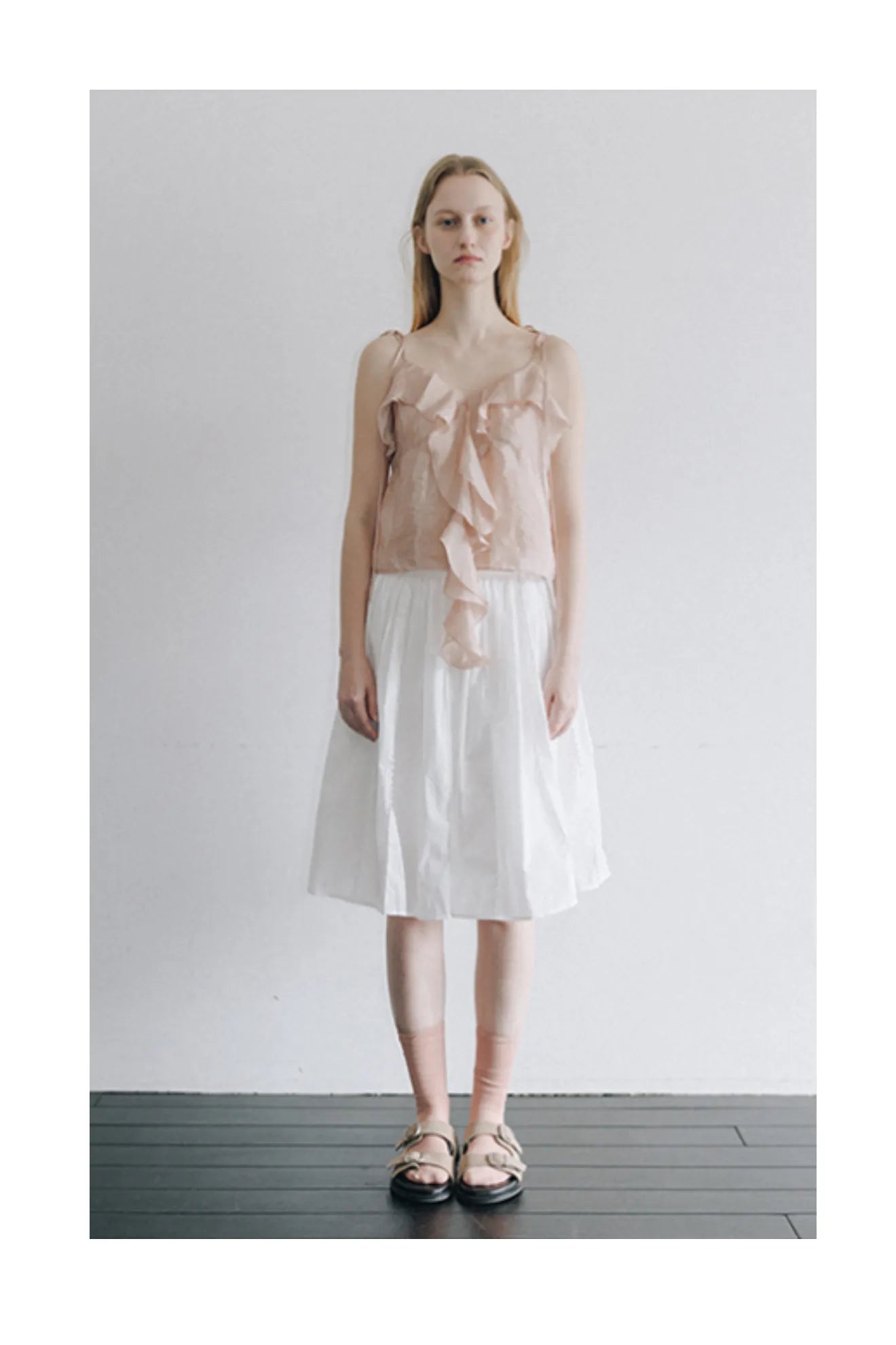 Model wearing Atelier Edition Embroidered Ruffle Blouse in Light Pink
