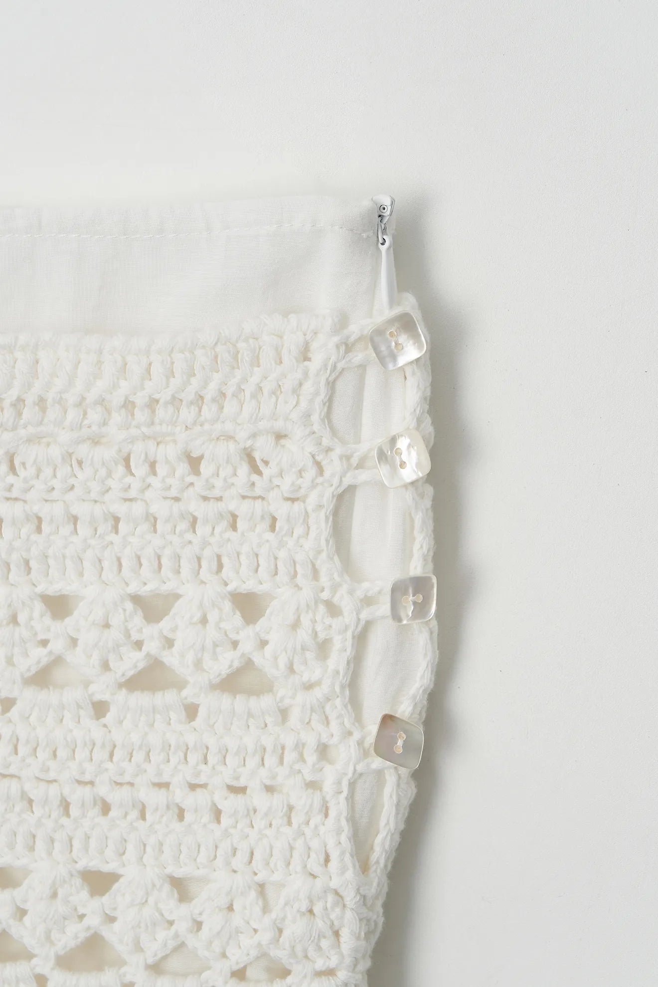 Hand-knitted side detail on Atelier Edition Frill Skirt Ivory