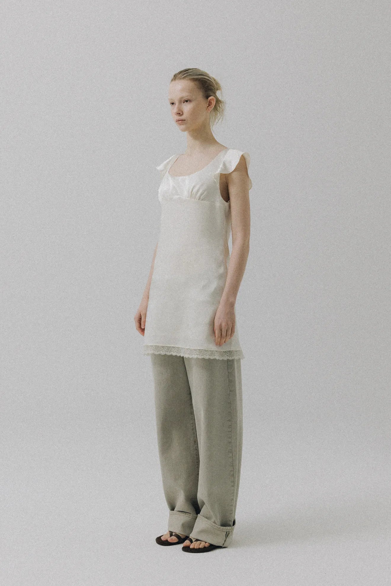 Model wearing Atelier Edition Overdyed Denim Light Khaki jeans