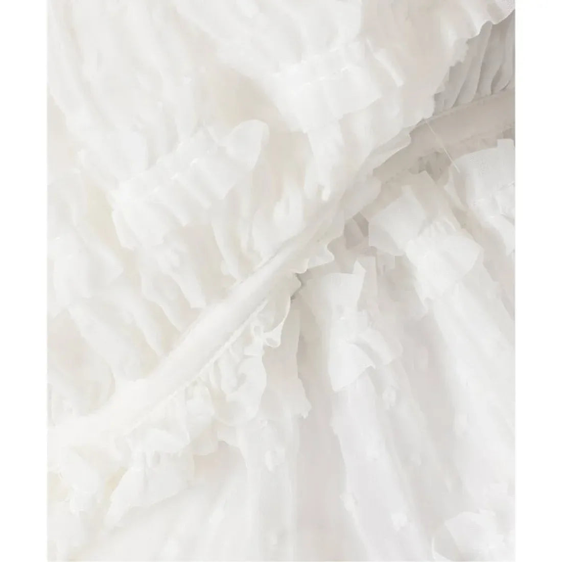 Close-up shirring and pleated fabric detail of Atelier Edition Shirring String Pleated Top in White