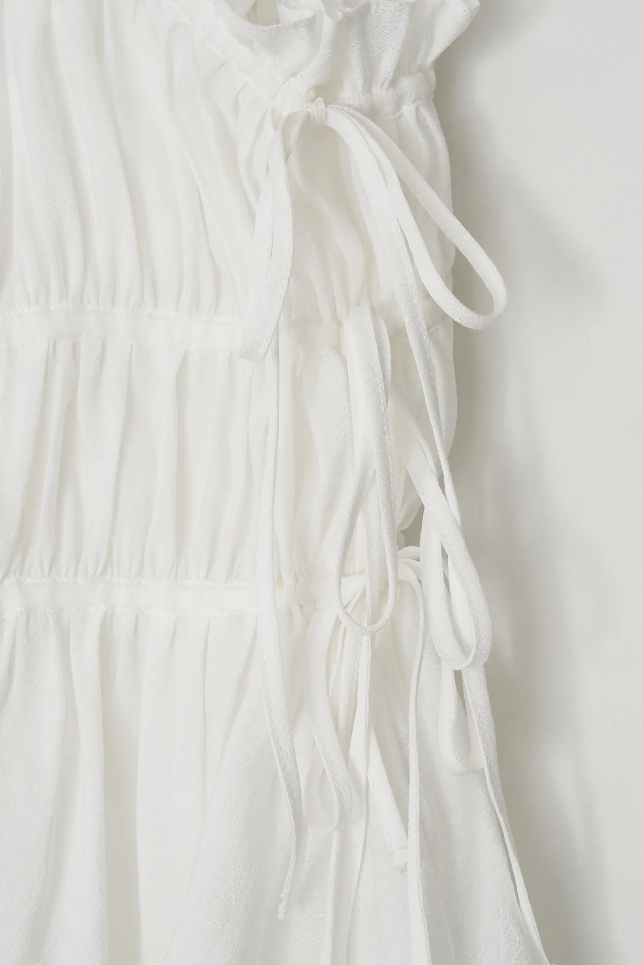 Adjustable side string detail of Atelier Edition Shirring String Pleated Top White
