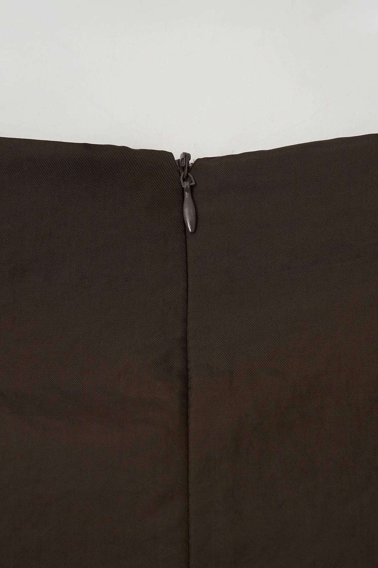 Back zipper detail on Atelier Edition Sleeveless Flounce Blouse Brown