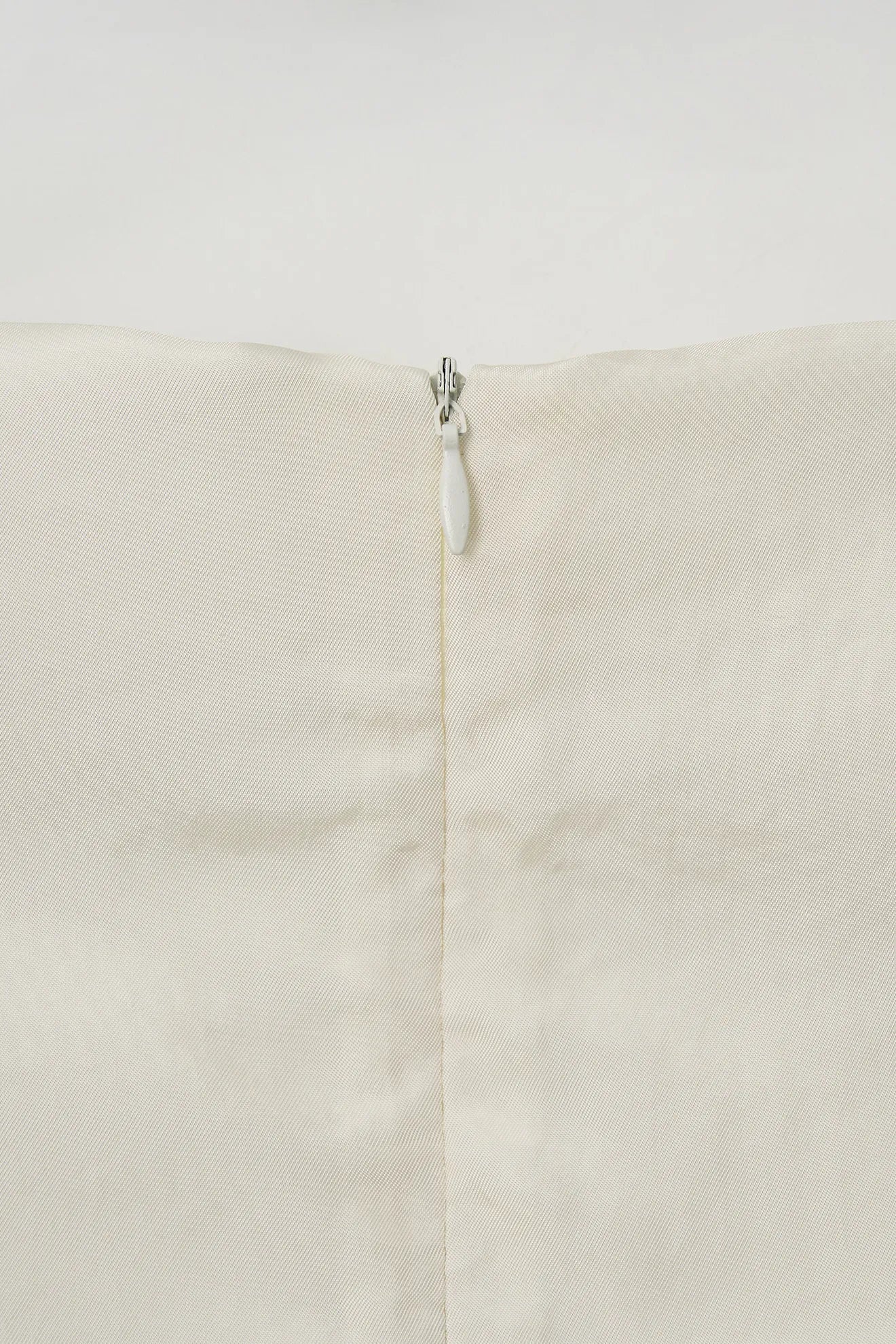 Back zipper detail on Atelier Edition Sleeveless Flounce Blouse Cream