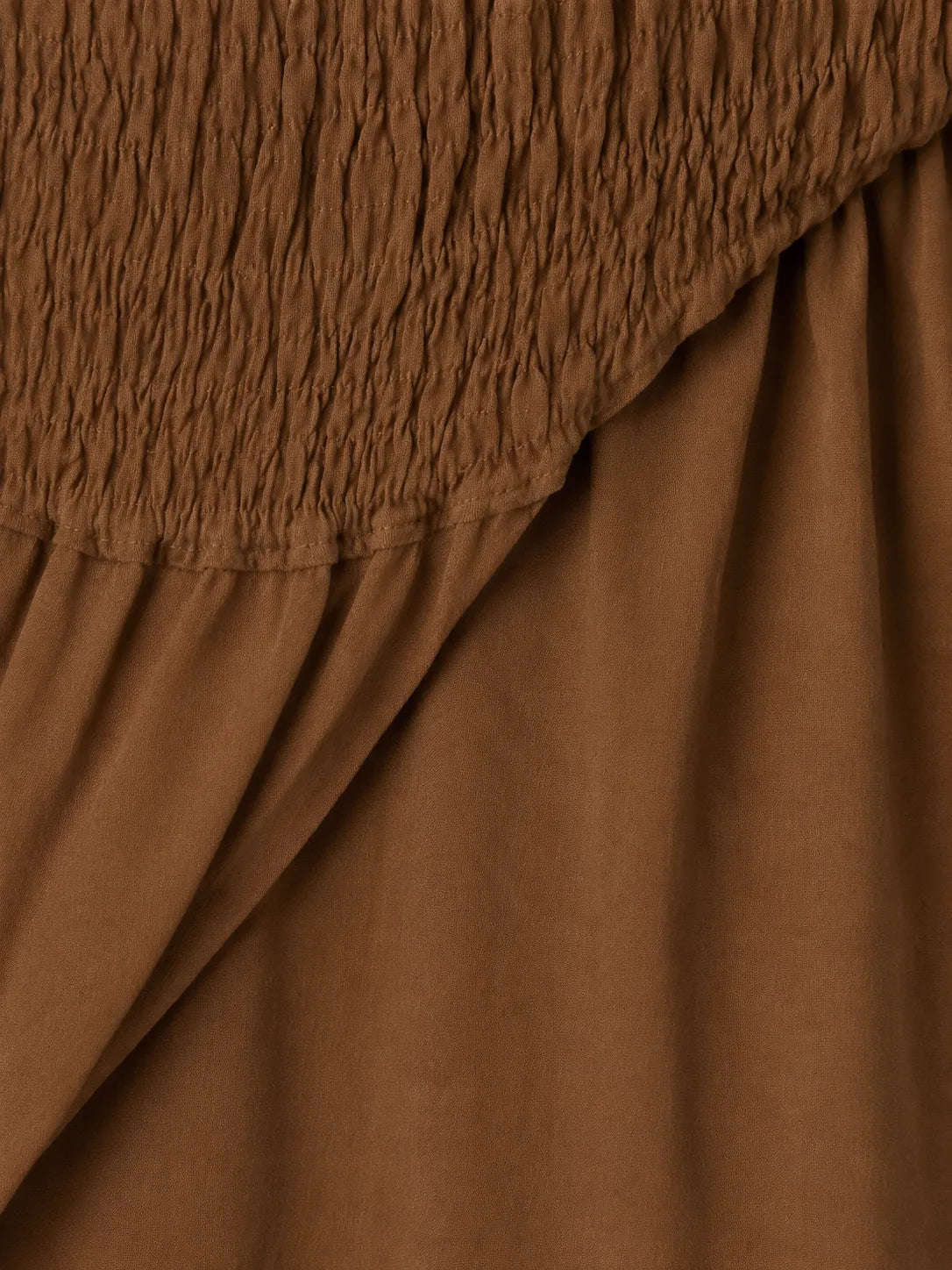 Side view of Atelier Edition Wrinkle Smocked Dress in Brown