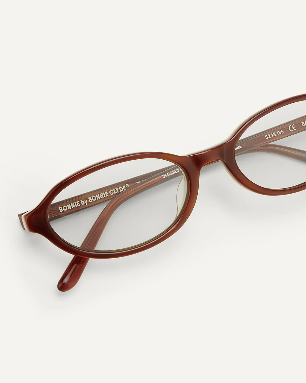 Detail of Bonnie Clyde baby sunglasses layered brown clear acetate frame