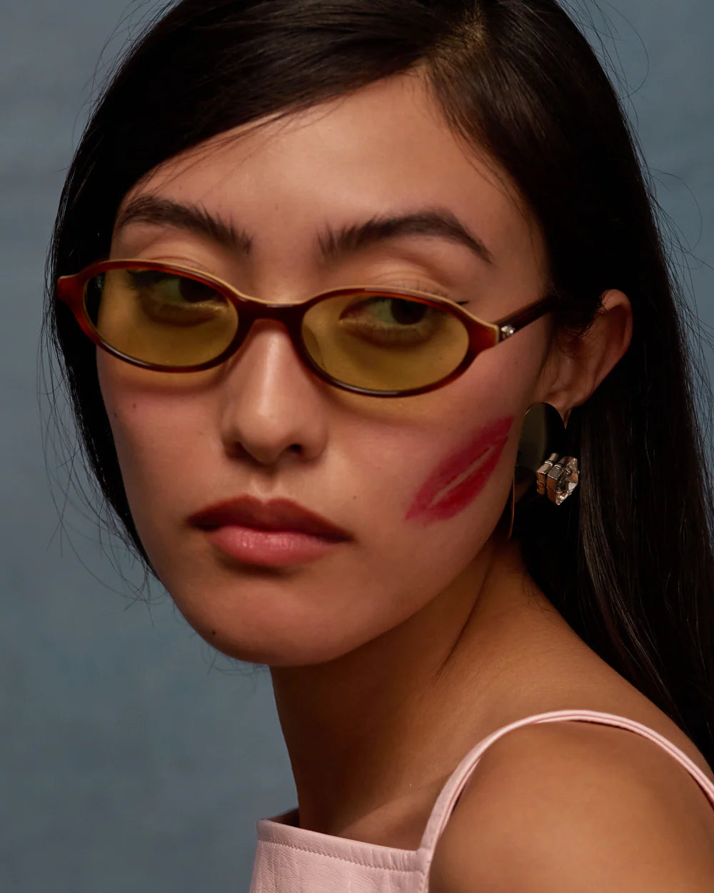 Model wearing Bonnie Clyde baby sunglasses layered brown green tint oval slim fit