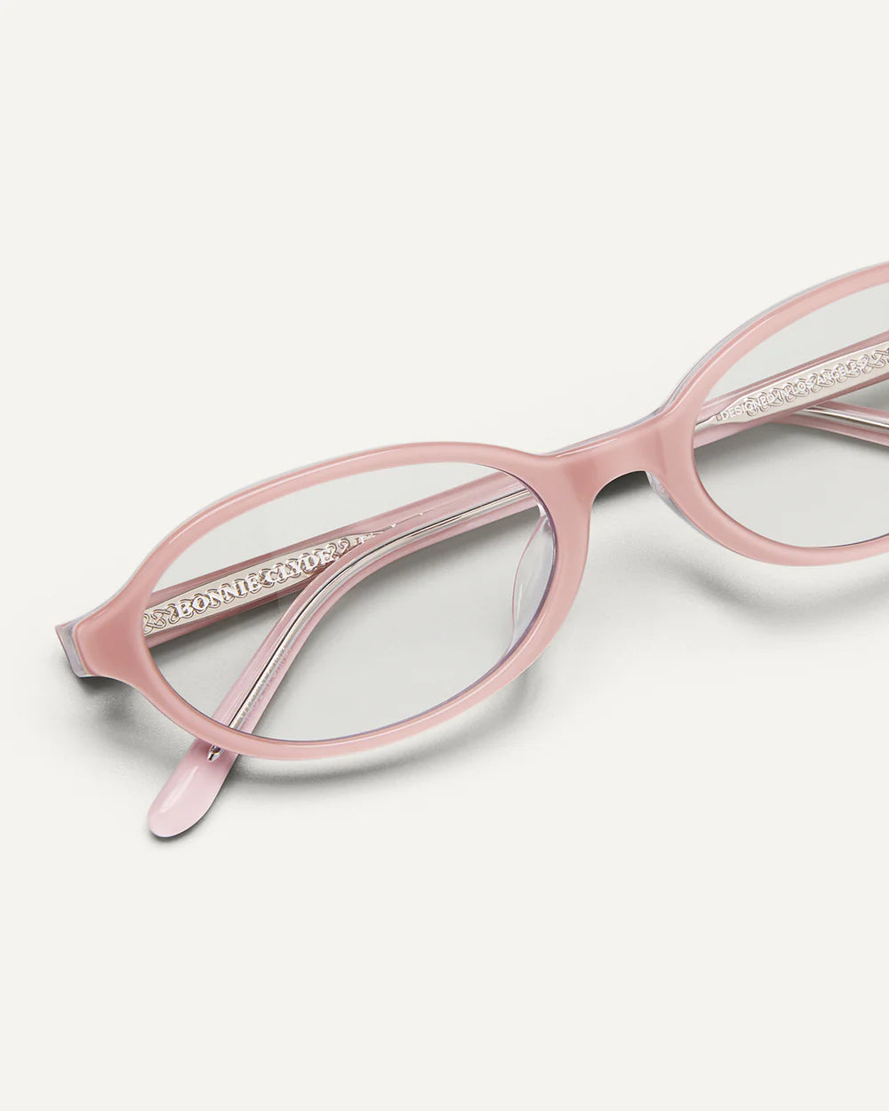 Close-up Bonnie Clyde Baby sunglasses pink clear frame with transparent lenses
