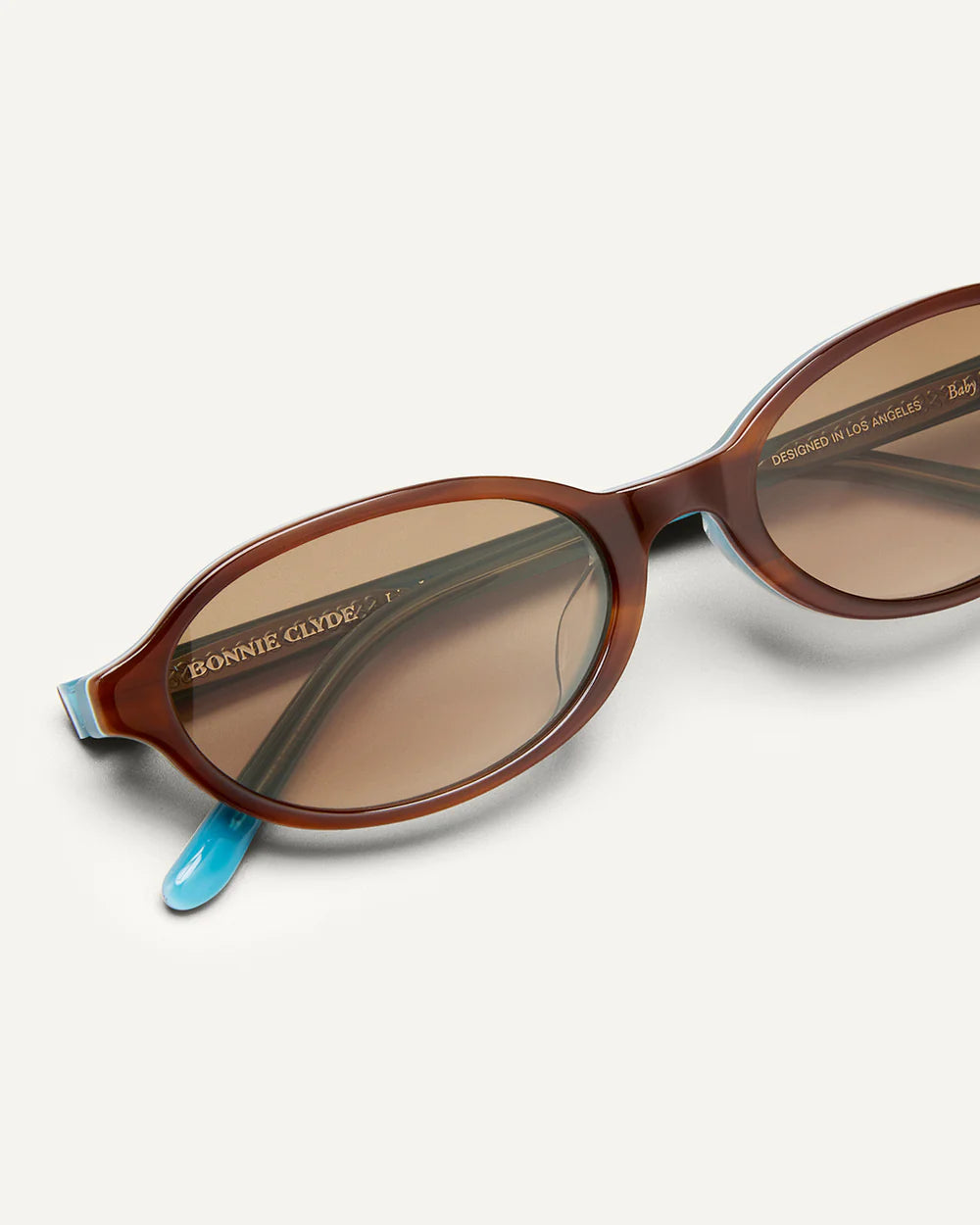 Frame detail of Bonnie Clyde Baby Sunglasses Layered Teal Demi Brown Gradient