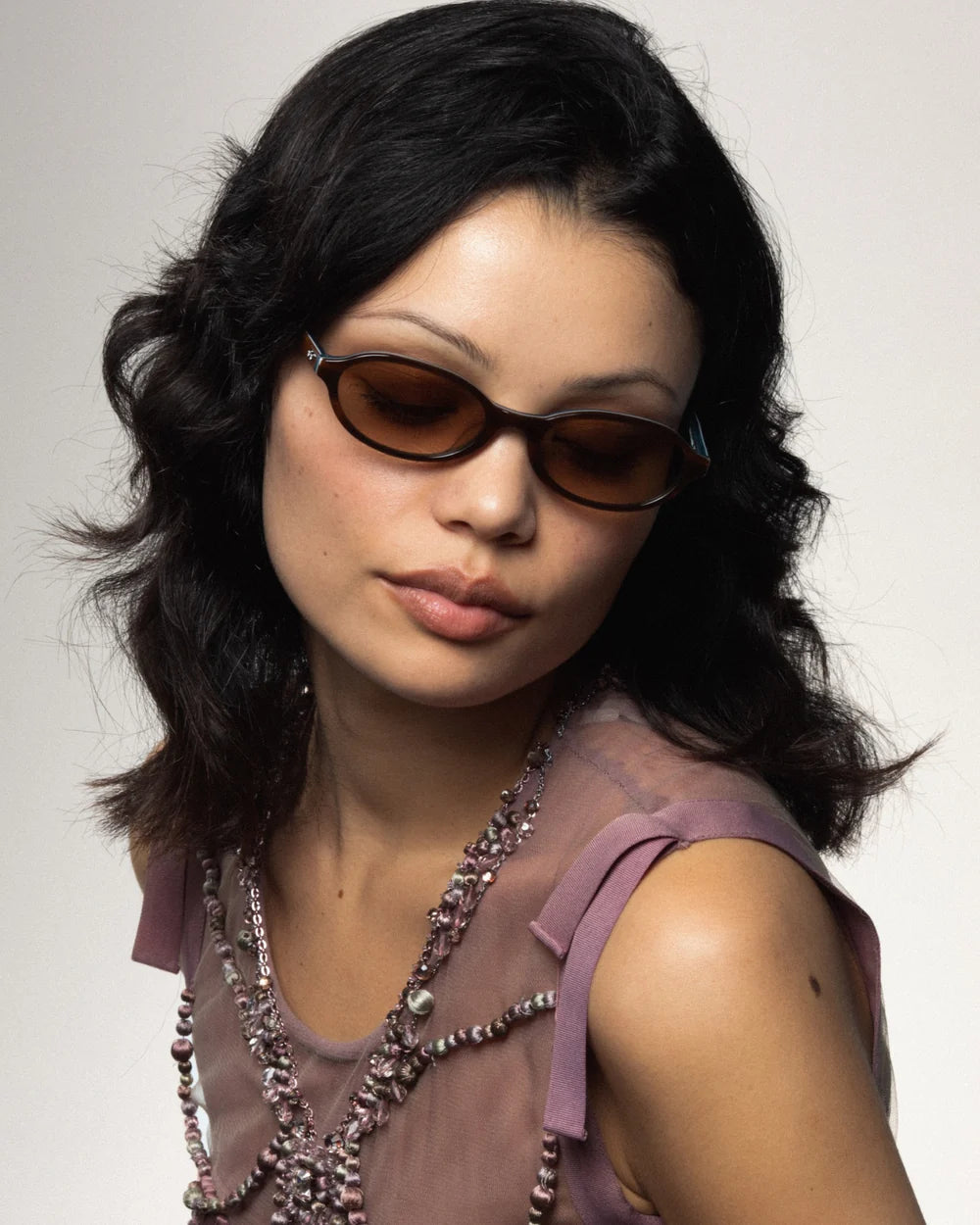 Model wearing Bonnie Clyde Baby Sunglasses Layered Teal Demi Brown Gradient