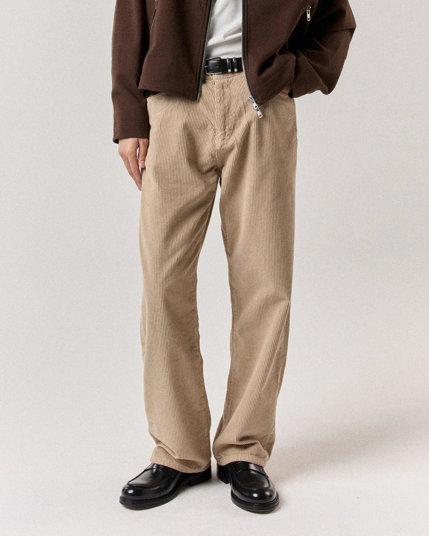 Brown corduroy jeans on body detail view