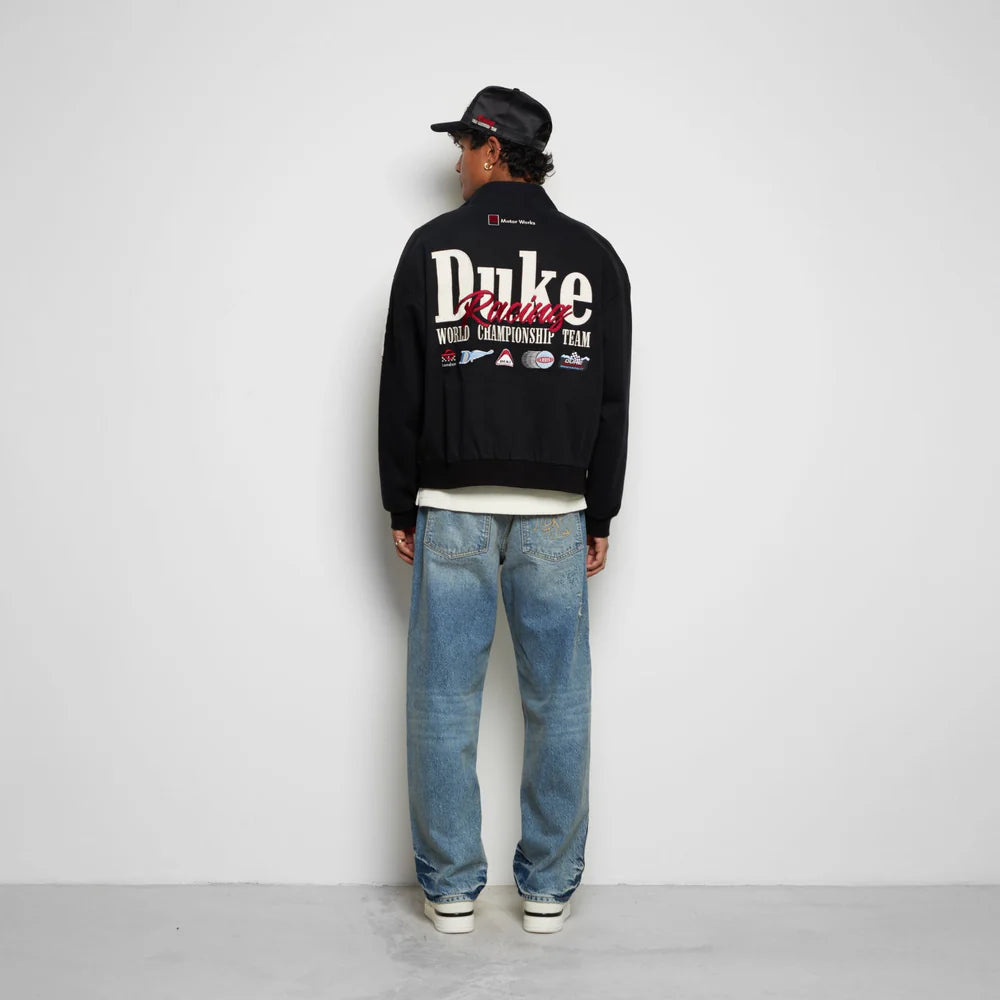 Back view of model wearing Duke + Dexter DR1 World Championship Vintage Black Jacket