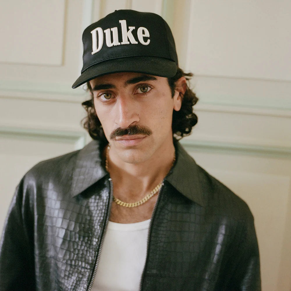 Model wearing Duke + Dexter Duke Black Cap