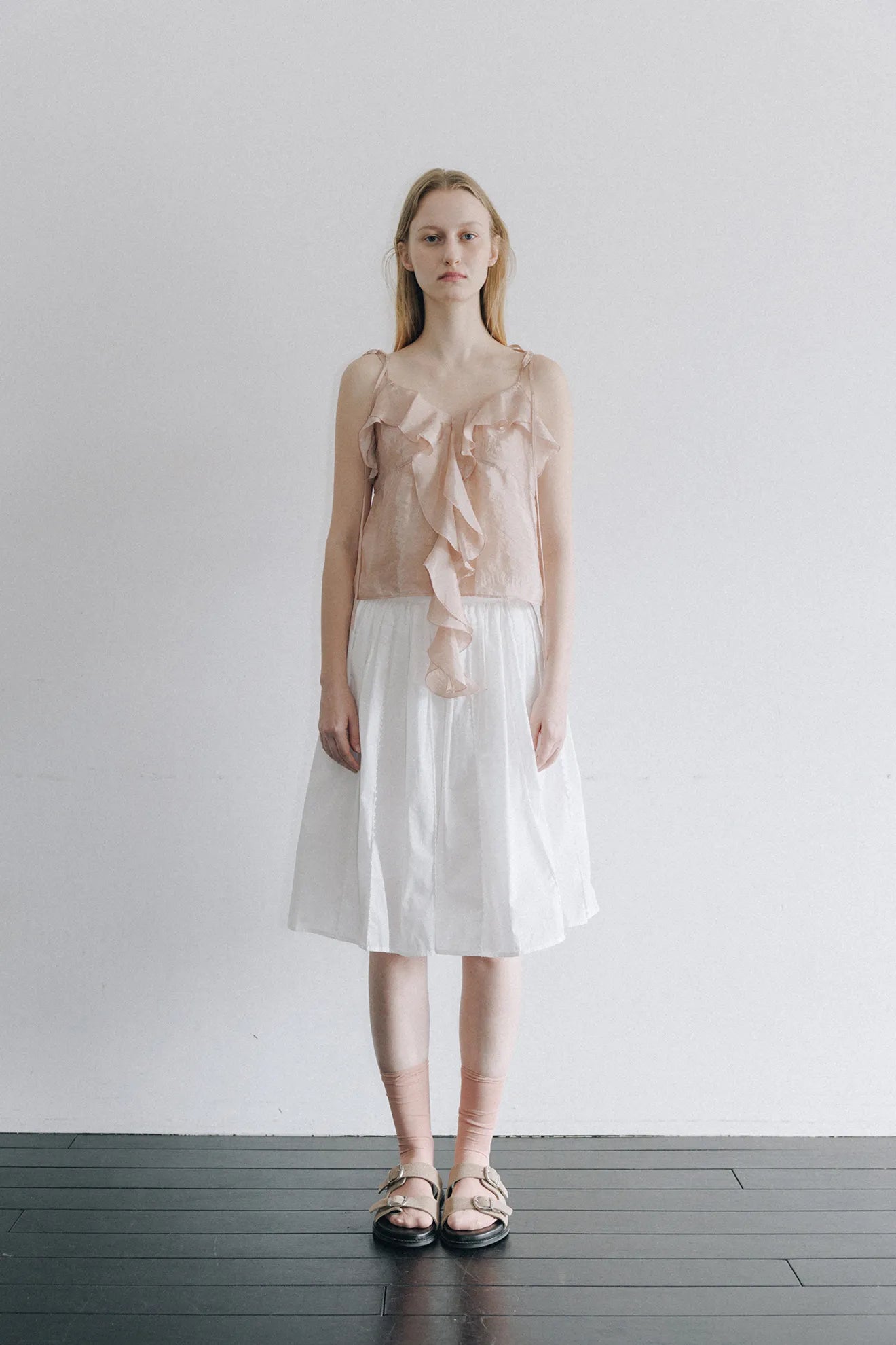 Model wearing Embroidered Ruffle Blouse in Light Pink