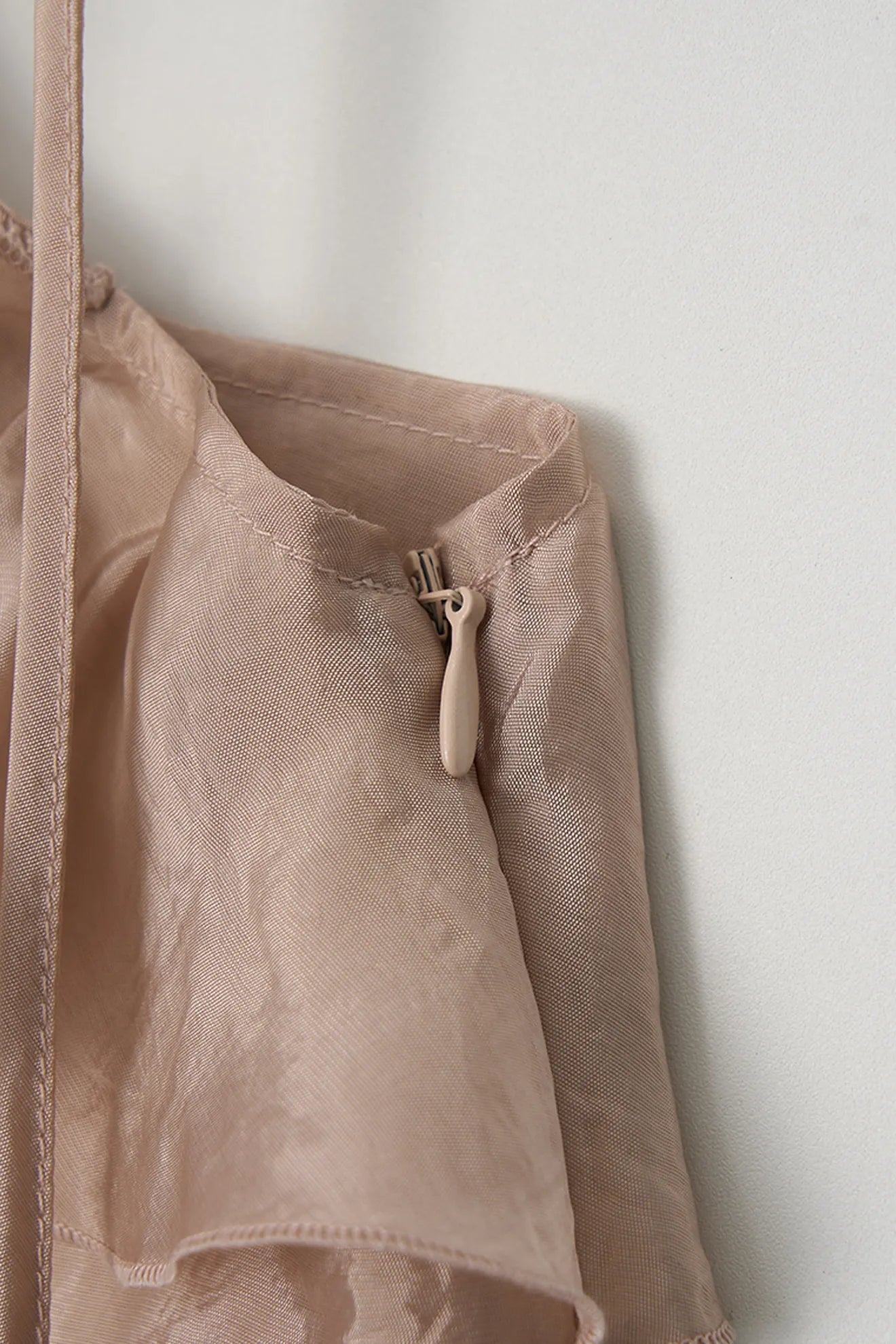 Side zipper detail of Embroidered Ruffle Blouse in Light Pink