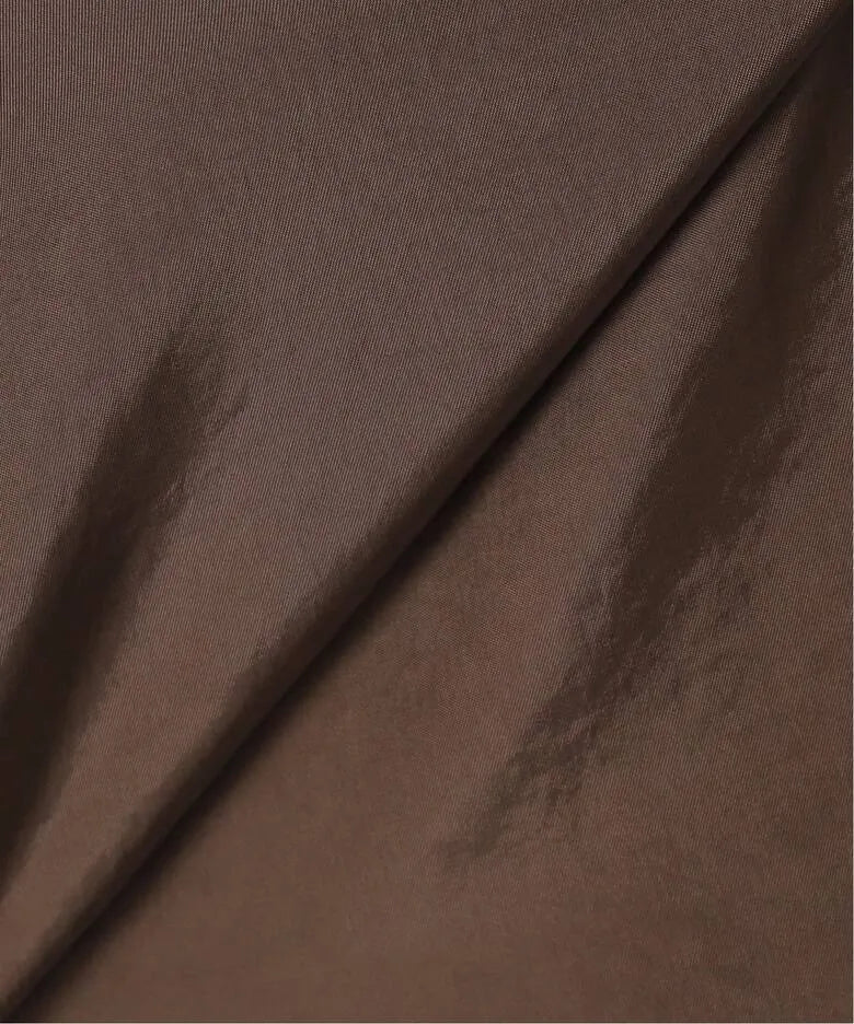 Surface texture detail of Atelier Edition Flounce Detail Dress in Brown