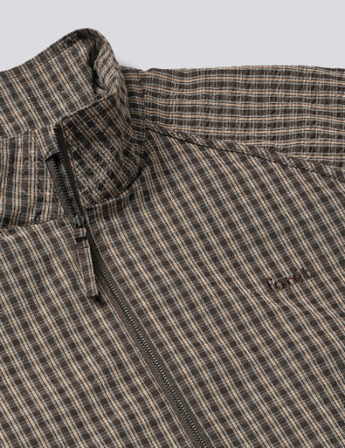 Collar detail of Foret Stream Track Jacket in Wood Check