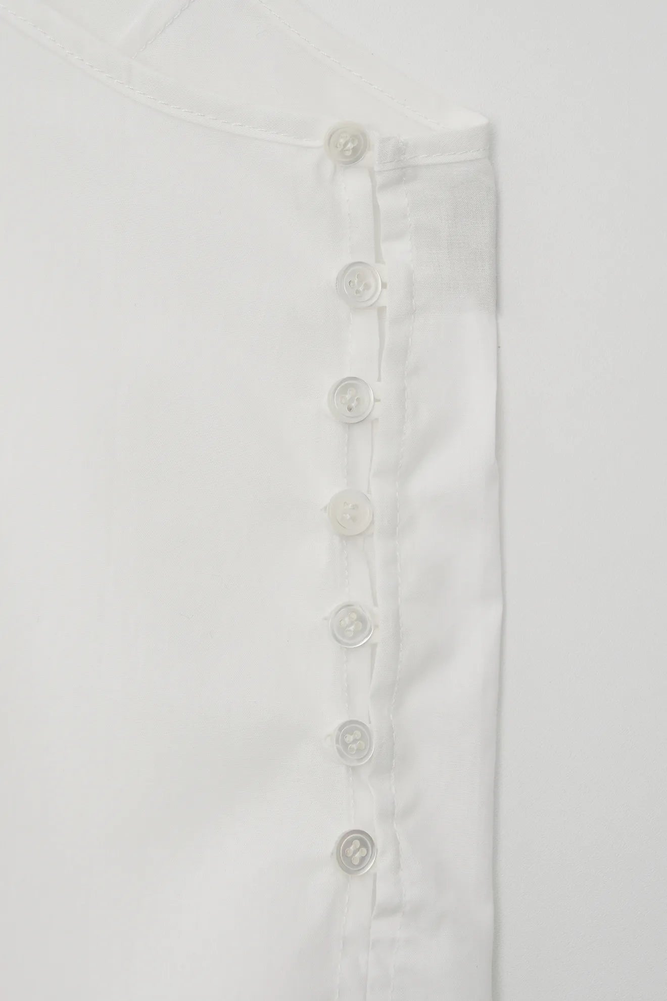 Button detail of Frilled and Embroidered Blouse in White