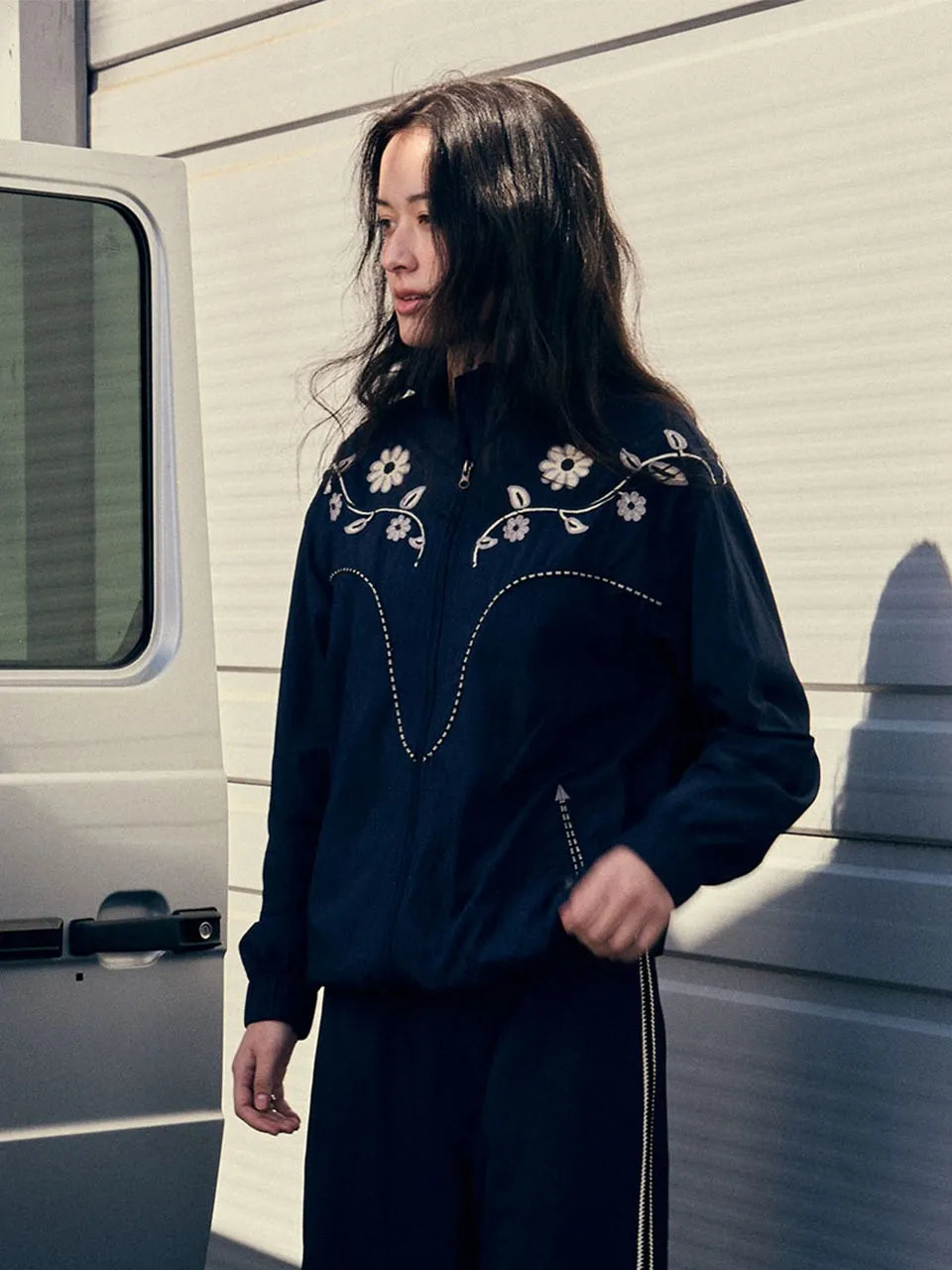 Model wearing FRITUR Embroidery Western Windbreaker in Navy