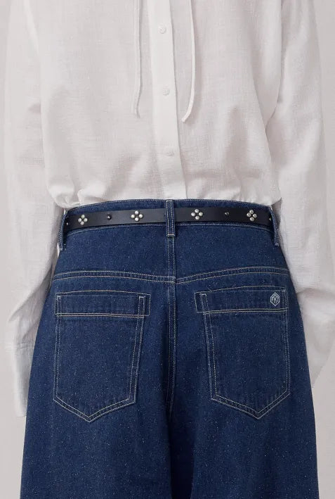 Back view of FRITUR Stud Leather Belt in Black worn with denim
