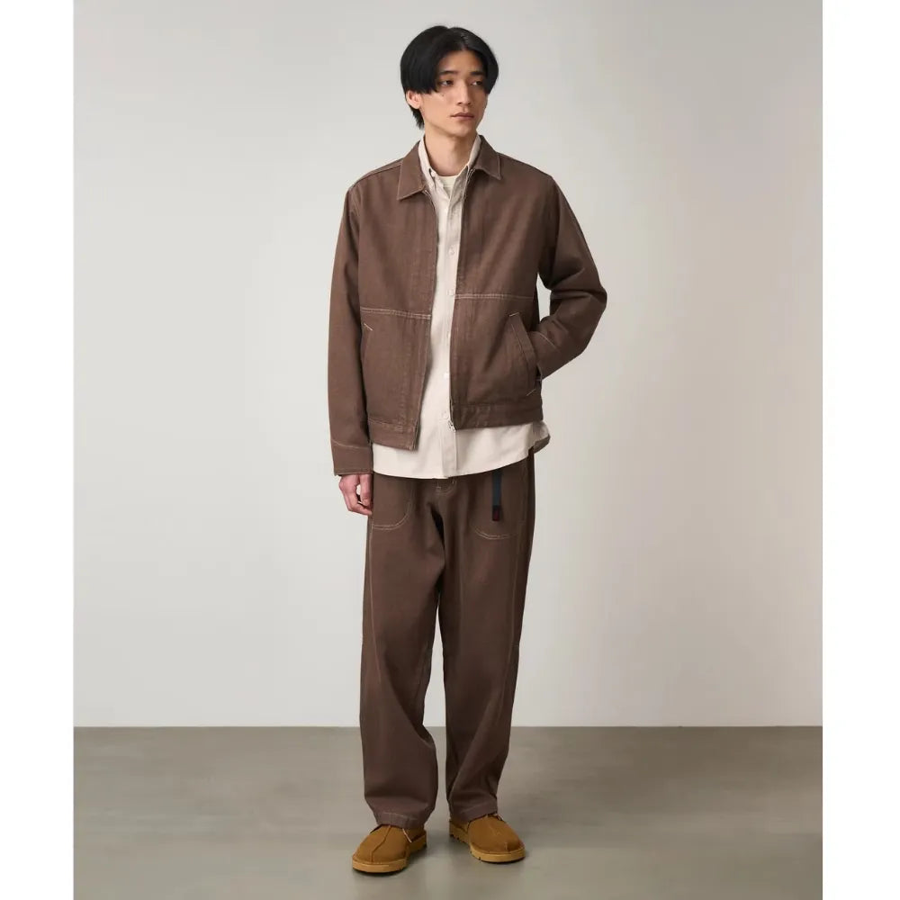 Model wearing Gramicci Men's Japanese Slub Denim Jacket in Amber