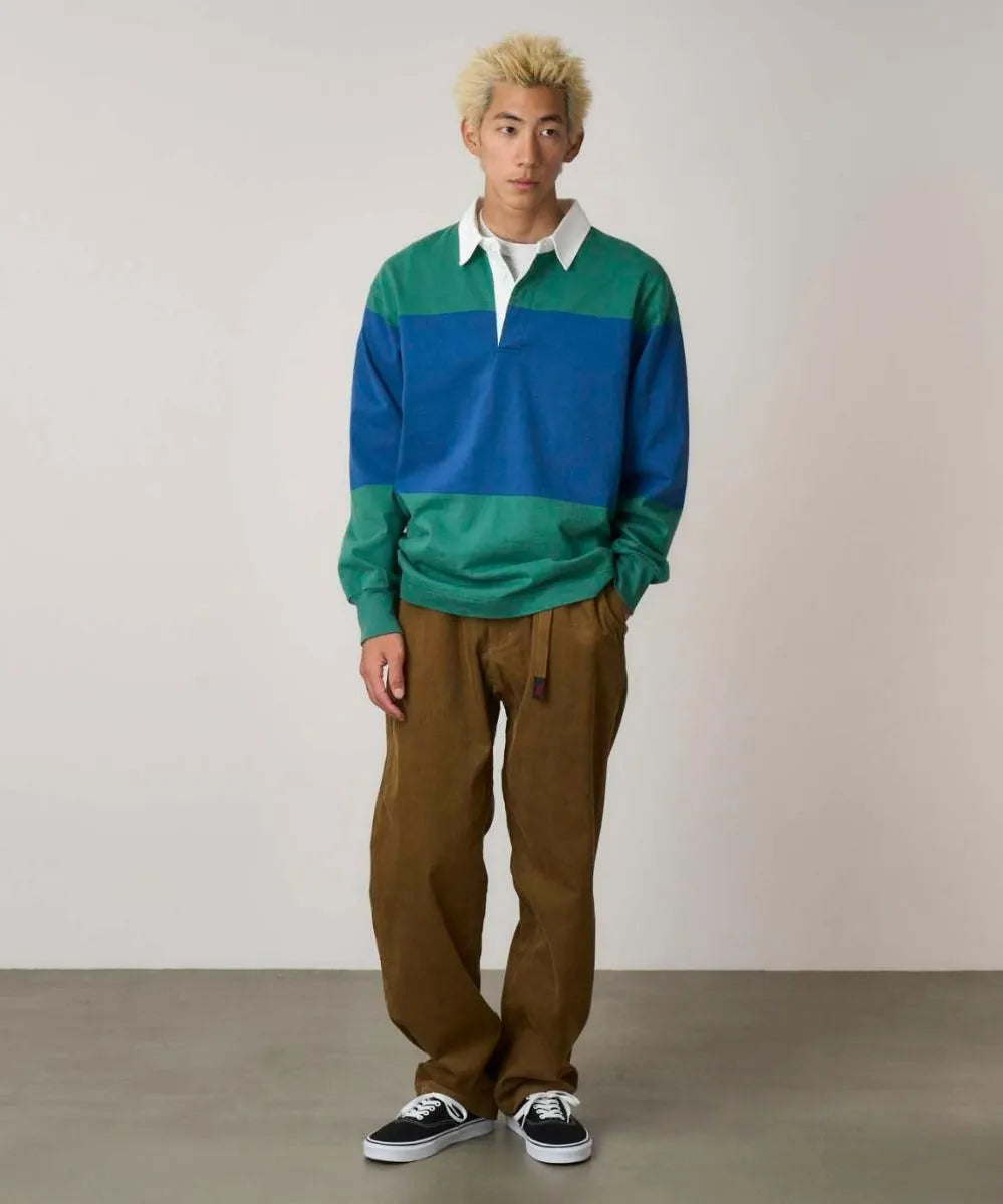 Model wearing Gramicci Men's Langdon Rugby Shirt in Cerulean and Emerald
