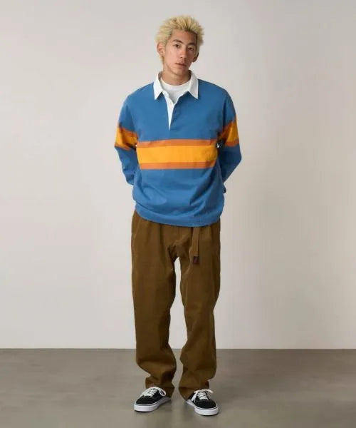 Model wearing Gramicci Men's Langdon Rugby Shirt in Sky and Apricot