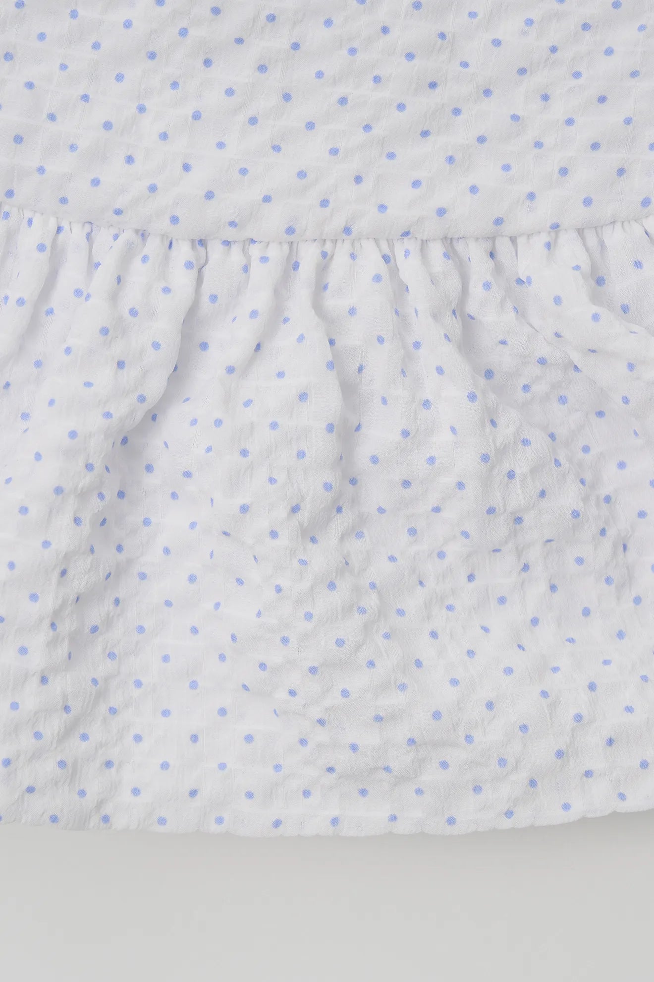 Textured fabric detail of Halterneck Peplum Blouse in White