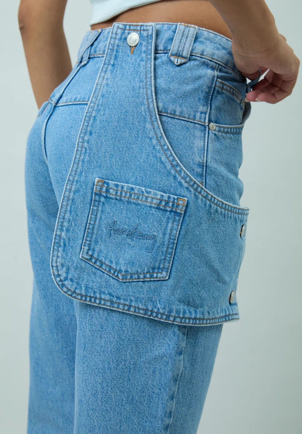 Back pocket detail of House of Sunny Cowboy Denim Jeans in Mid Blue Wash