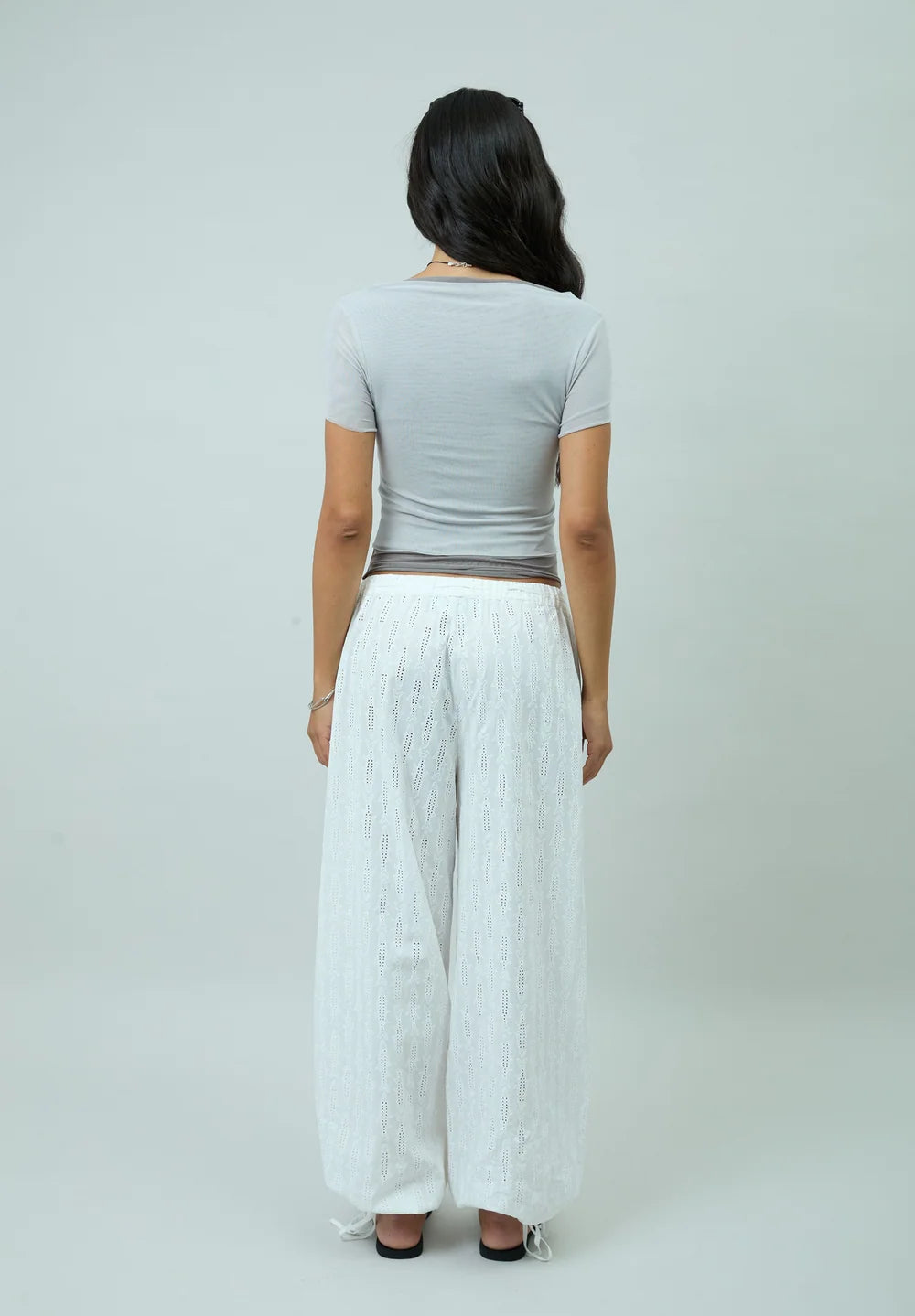 Back view of model wearing House of Sunny Double Layer Mesh Top in Grey