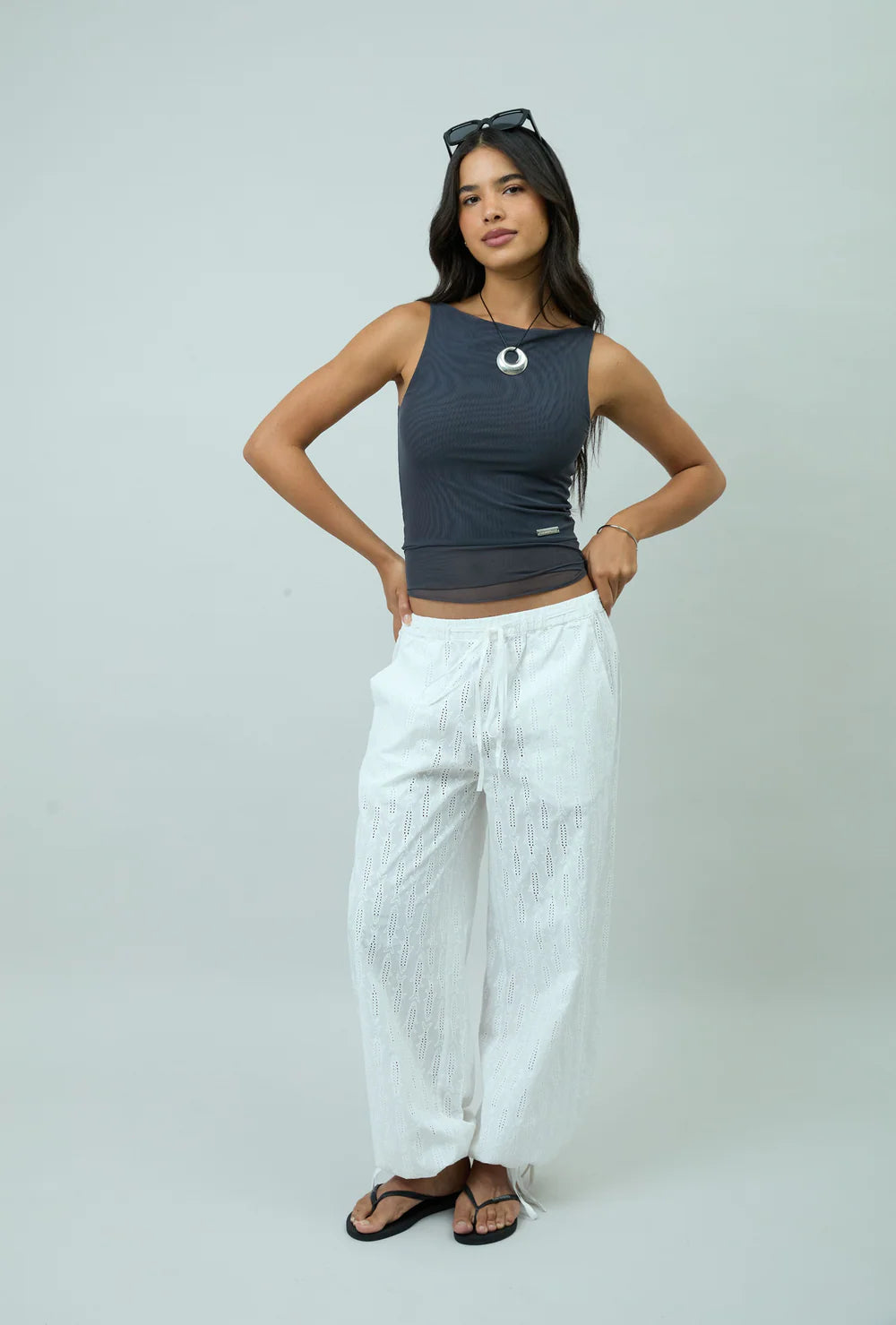 Three-quarter view of model wearing House of Sunny Double Layer Sleeveless Mesh Top in Steel Grey