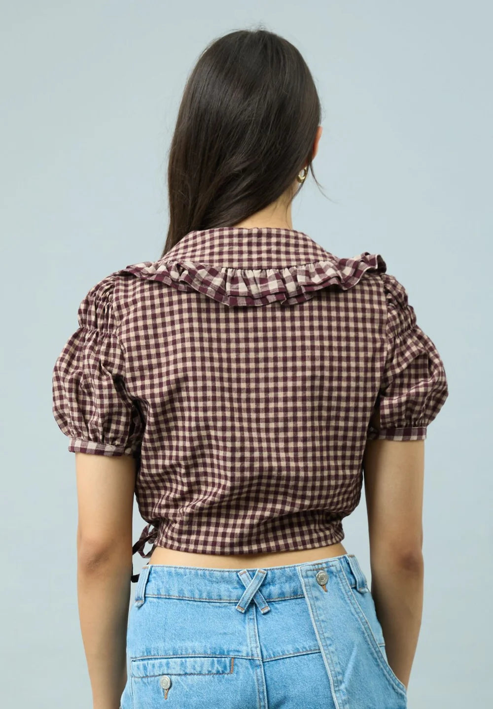 Back view of model wearing House of Sunny Gingham Ruffle Top