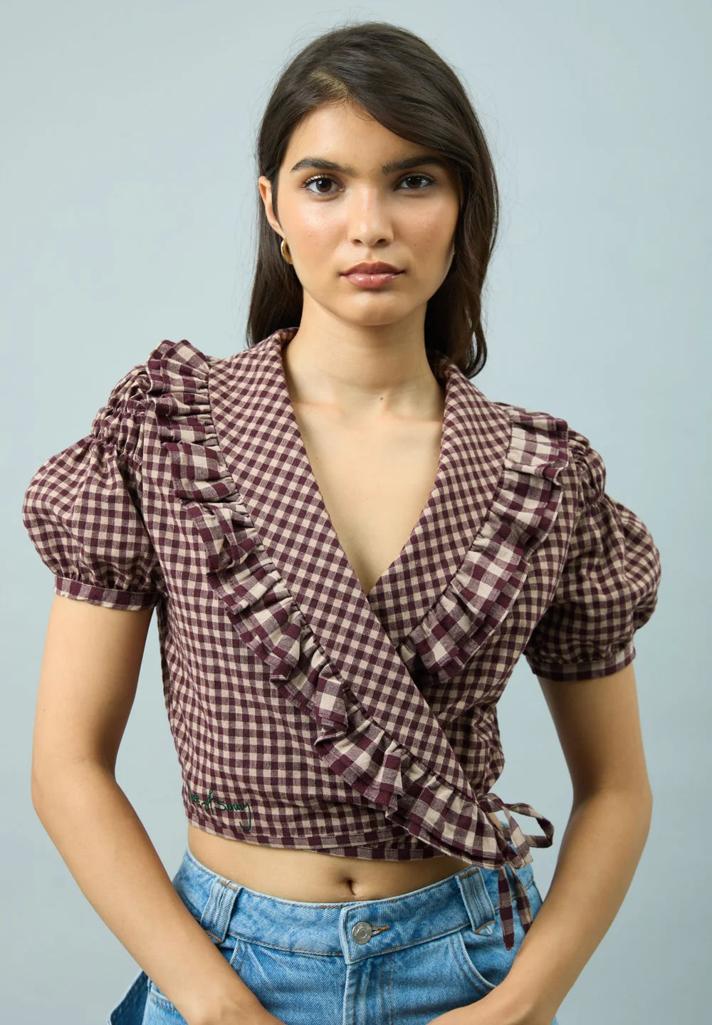 Close-up of model wearing House of Sunny Gingham Ruffle Top