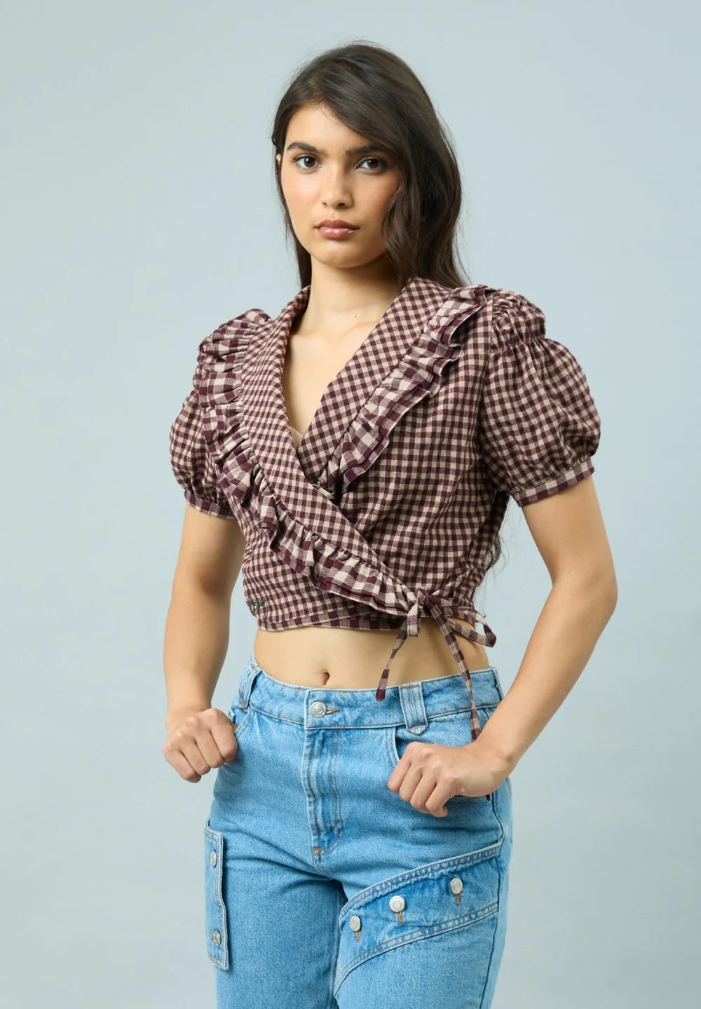 Three-quarter view of model wearing House of Sunny Gingham Ruffle Top