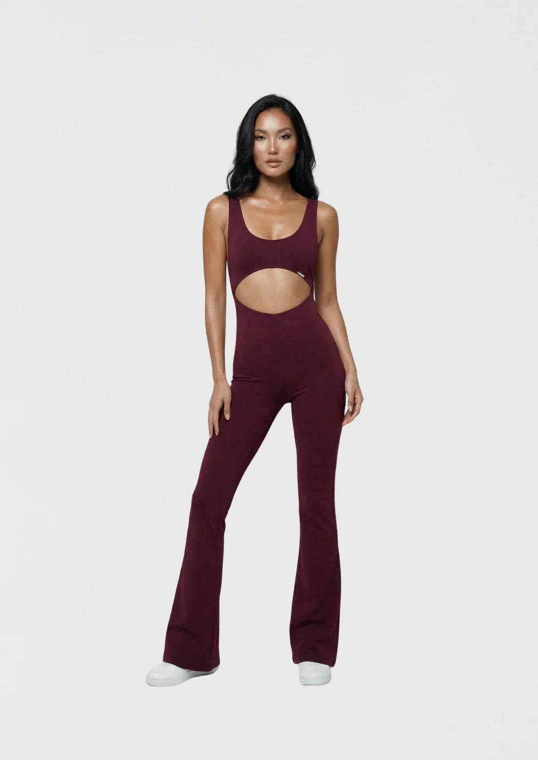 Model wearing WearRame Leda Dynamic Full Body Flare Onesie in Burgundy
