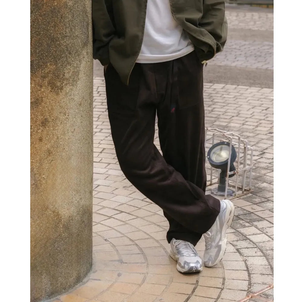 Model wearing Mizuno Wave Rider 10 in Light Beige Silver