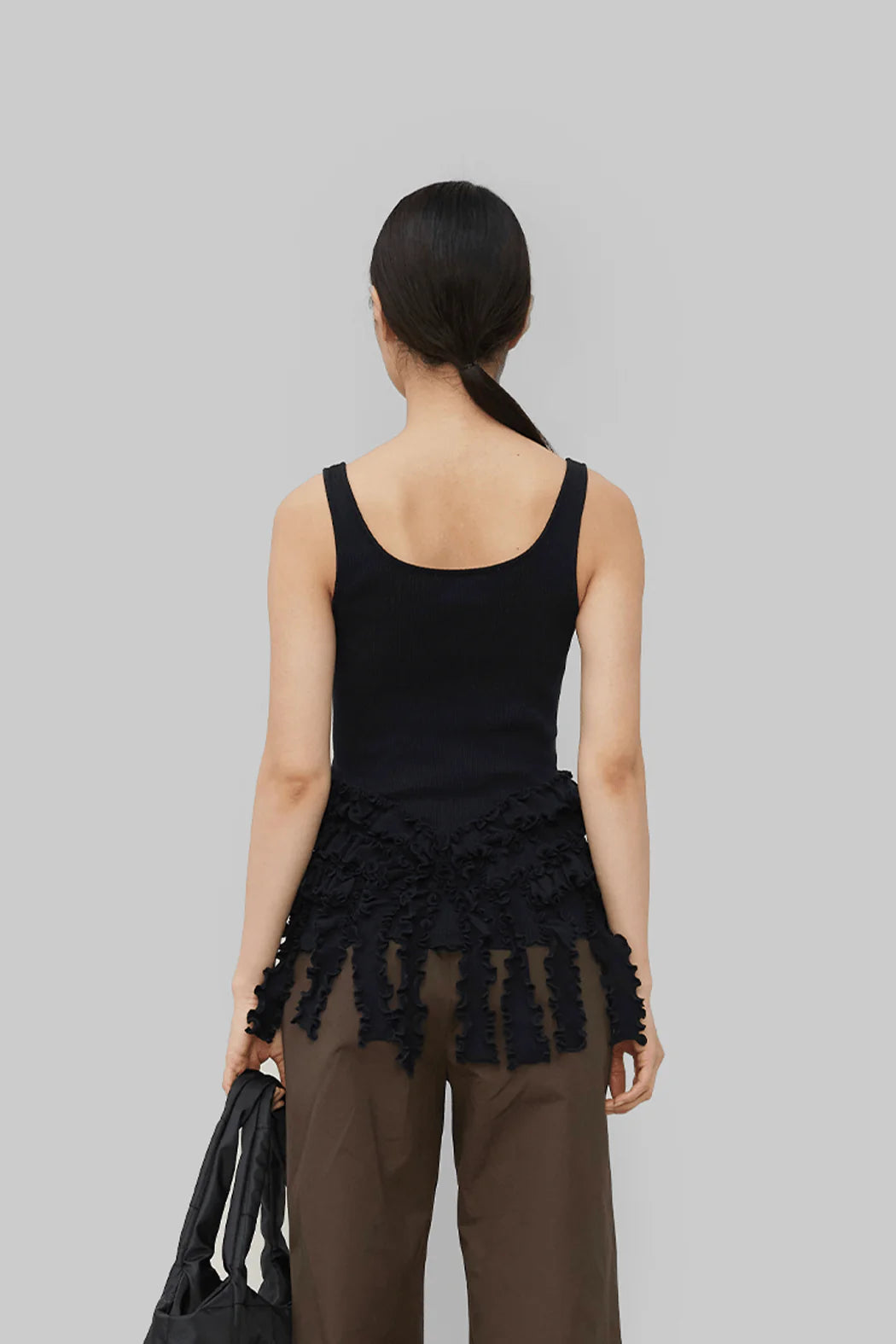 Back view of model wearing Mona Seamless Top in Black