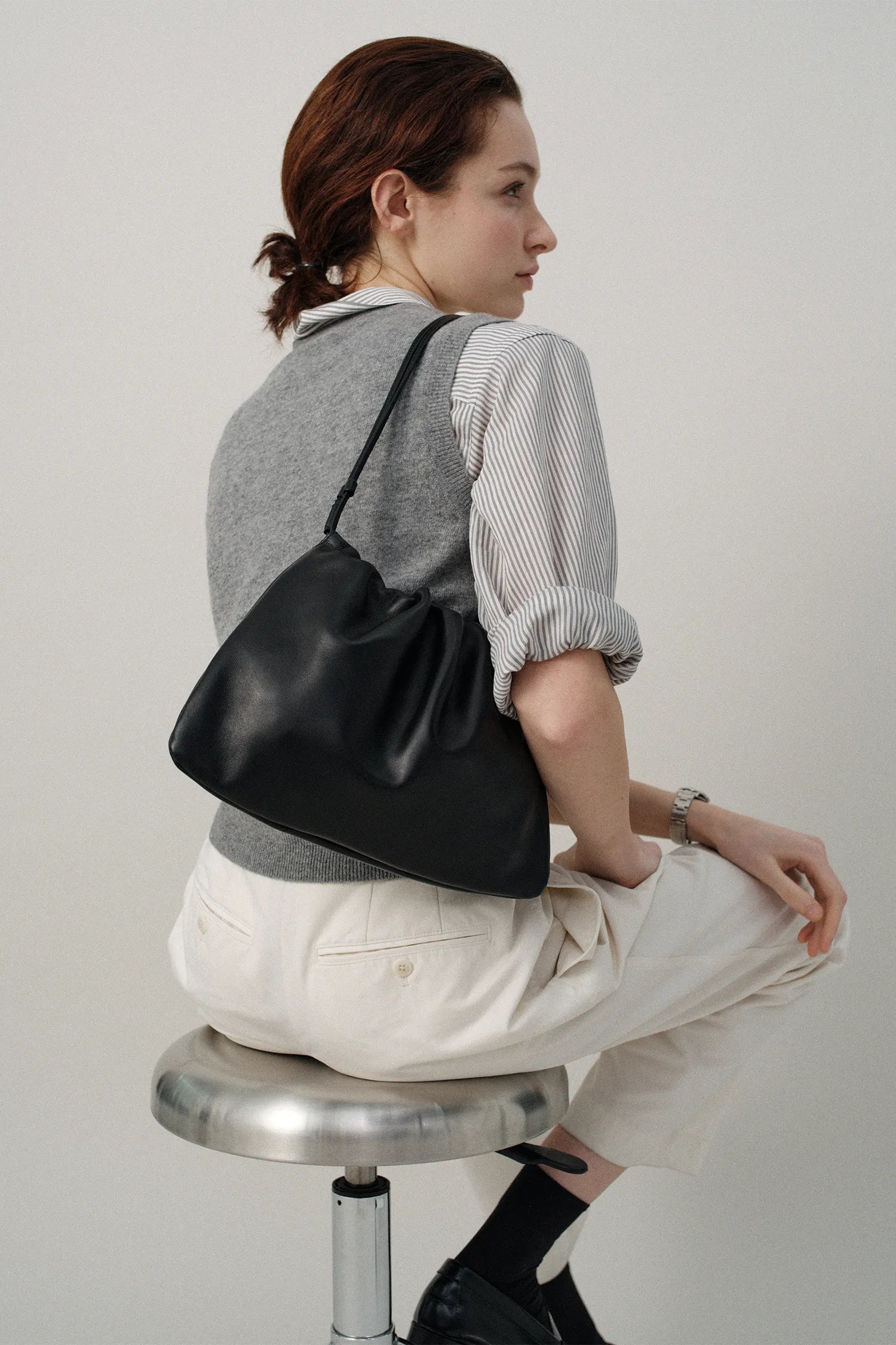Model carrying Nella Strap Large Bag Black shoulder view