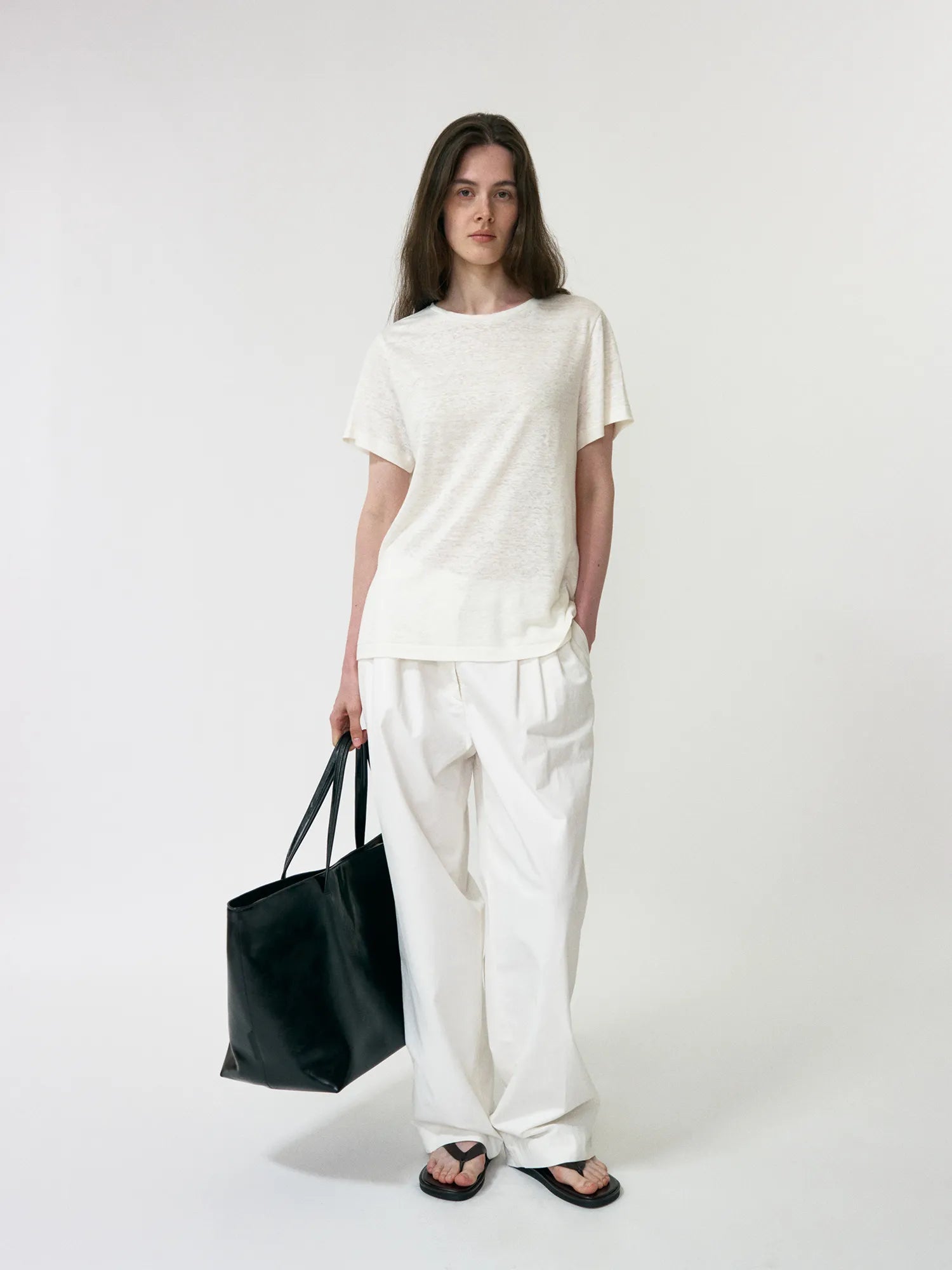 Model wearing NOTHING WRITTEN Lena 3-Tuck Pants in White