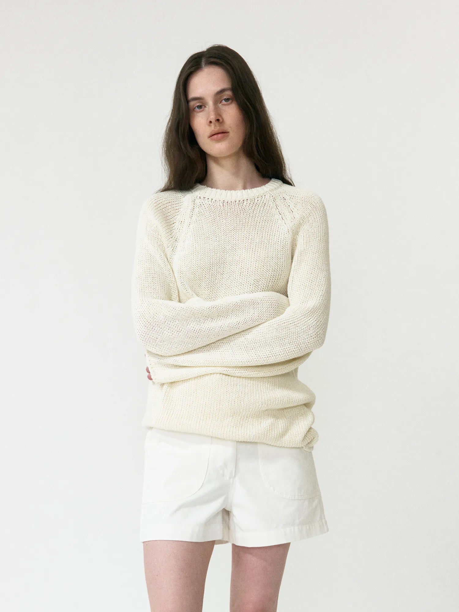 Model wearing NOTHING WRITTEN Washed Cotton Shorts in White Ivory