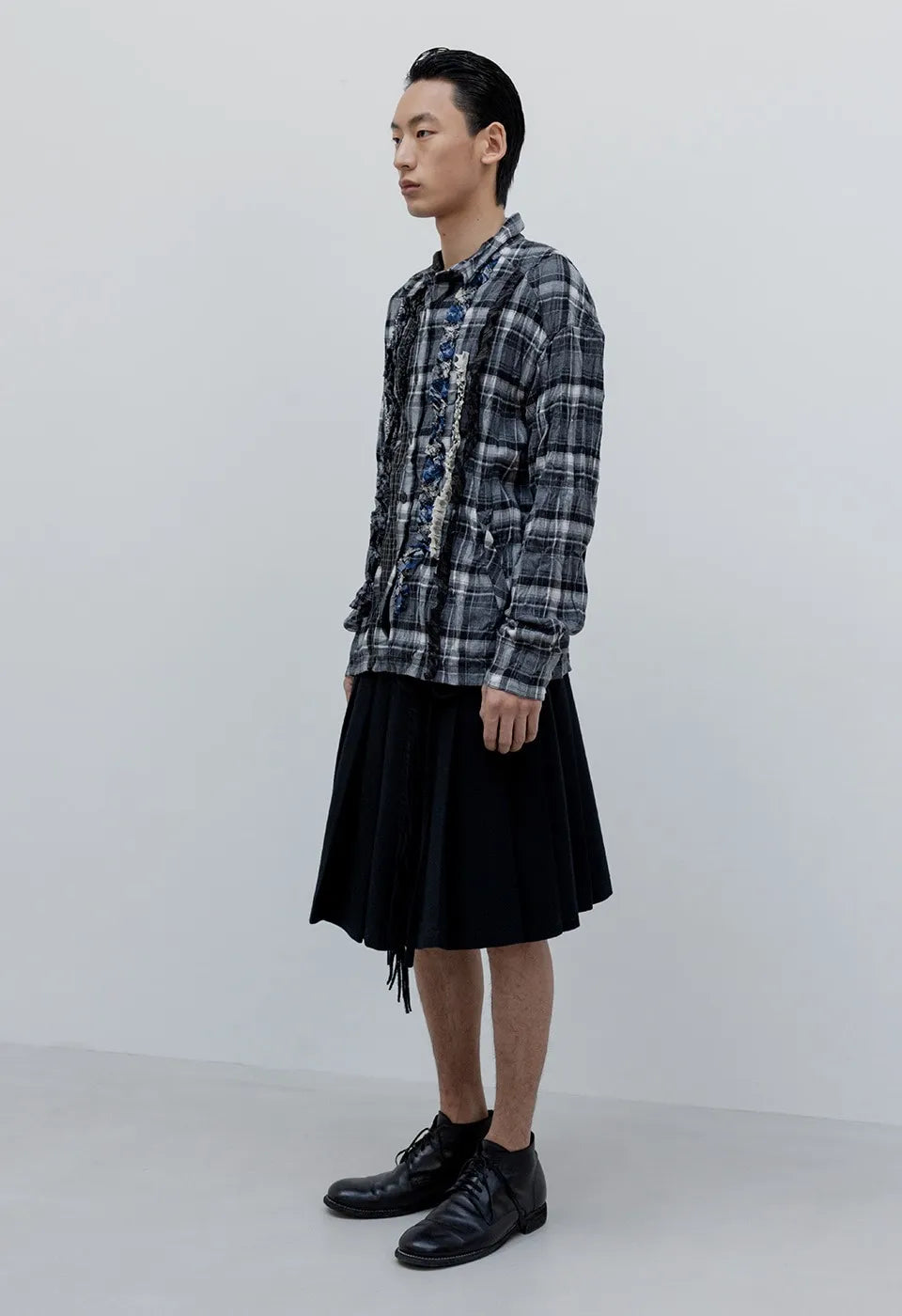 Side view of OPENYY Checkered Crinkle Ruffle Shirt in Black worn