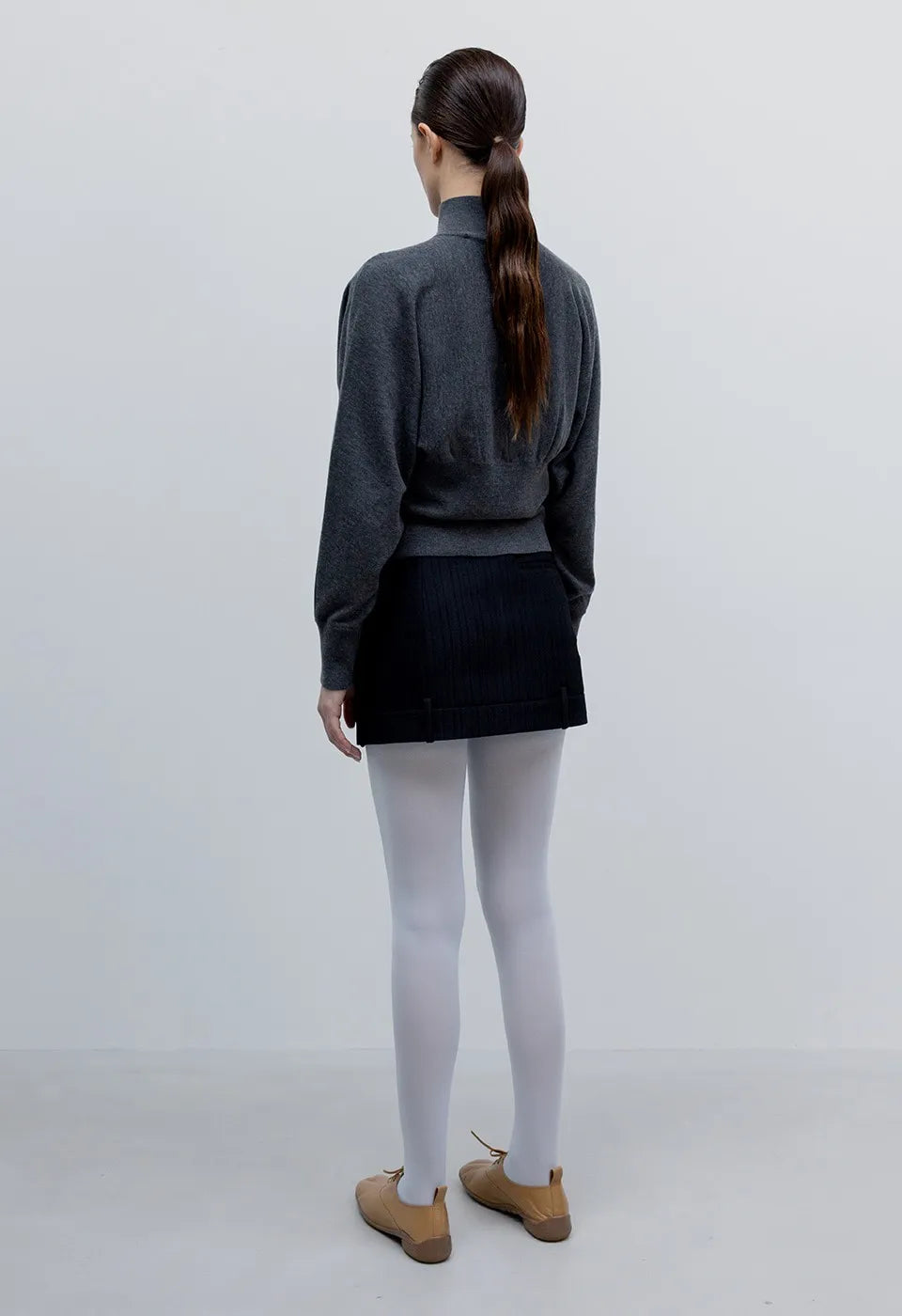Back view of OPENYY Knitted Button Up Blouson Cardigan in Charcoal Black worn