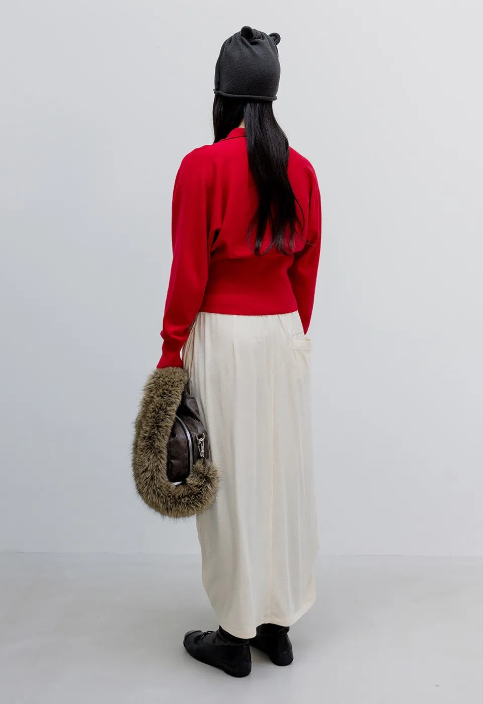 Back view of OPENYY Knitted Button Up Blouson Cardigan in Red worn
