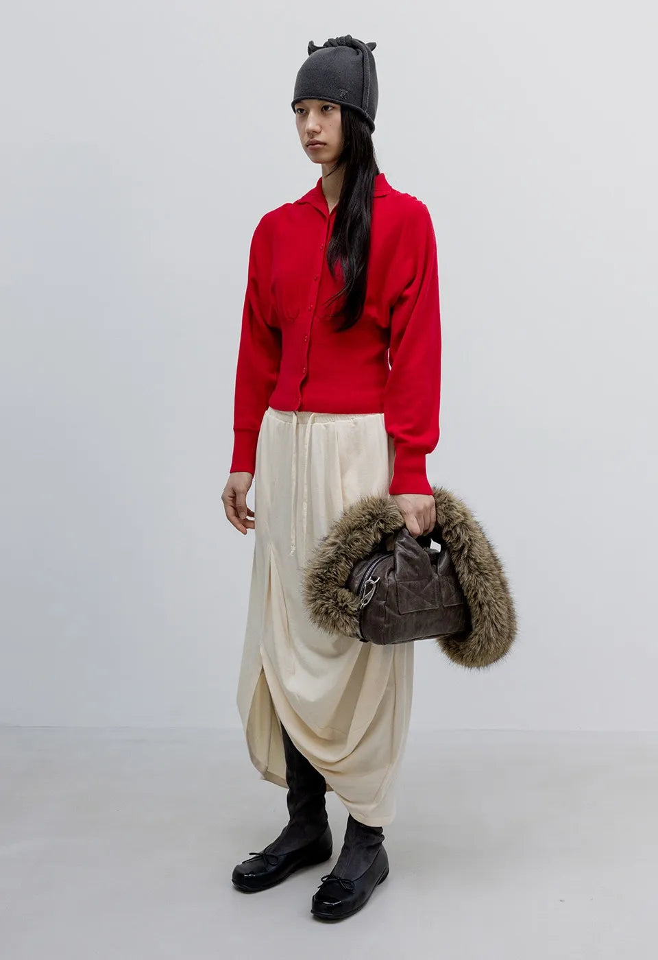 Side view of OPENYY Knitted Button Up Blouson Cardigan in Red worn