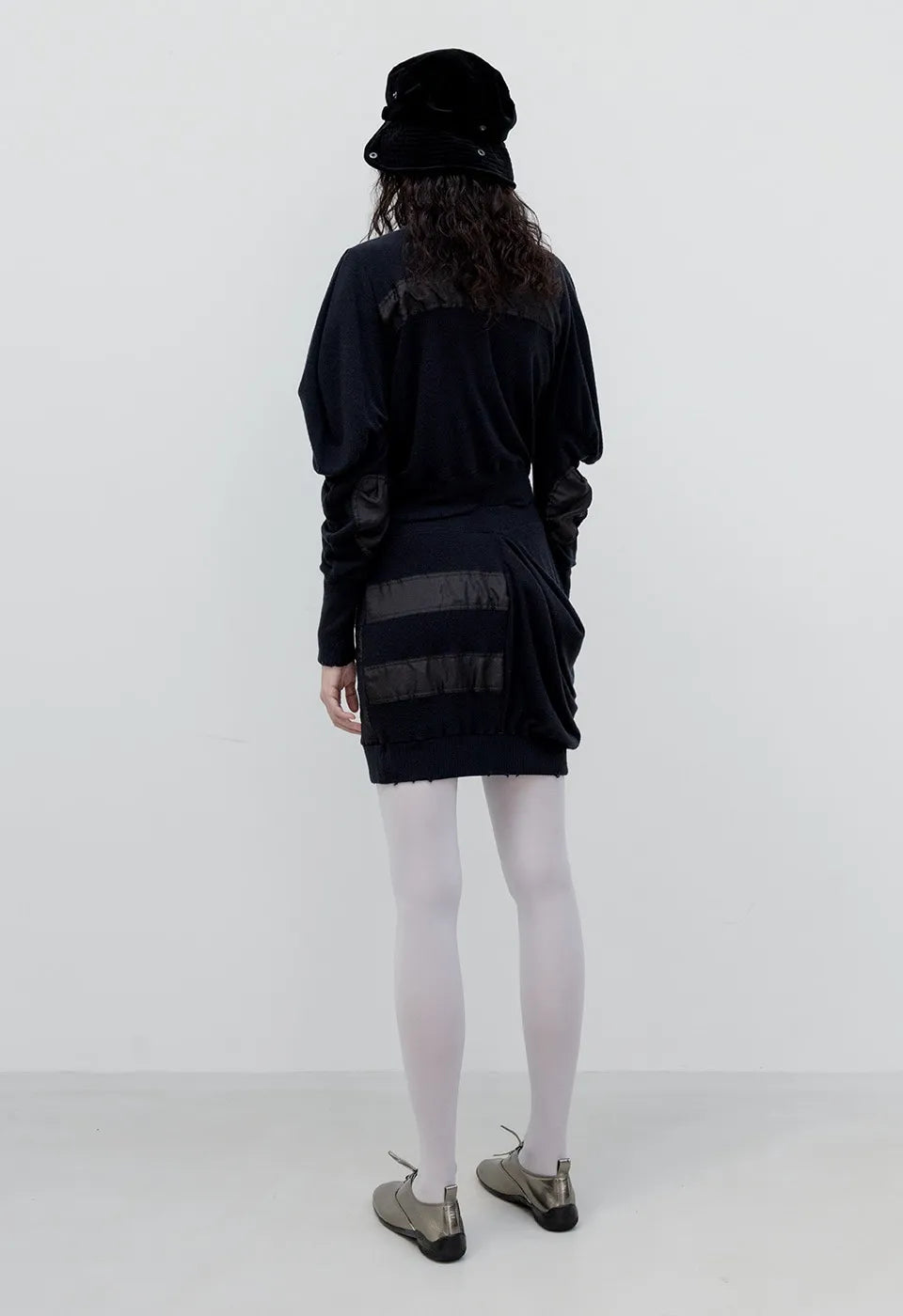 Back view of OPENYY Knitted Slouchy Panel Skirt in Black worn